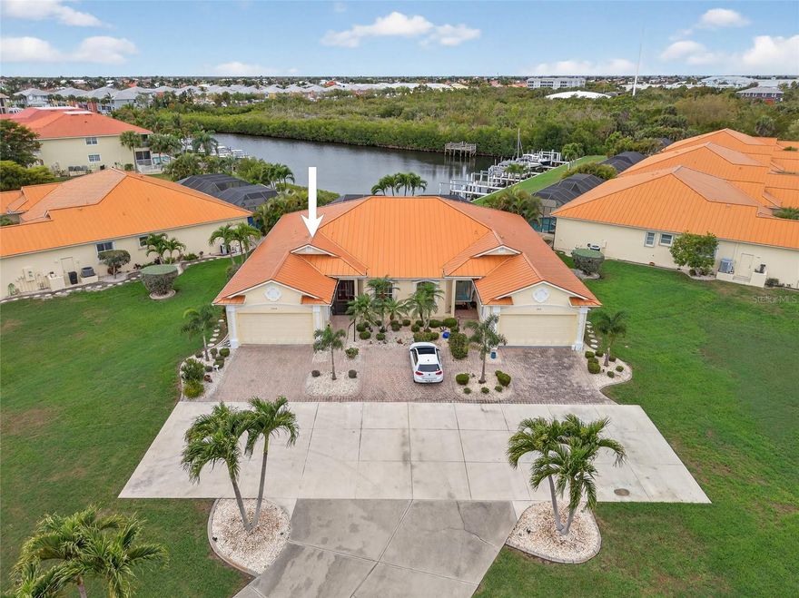 ONE OF A KIND! ADMIRALS POINT IS A UNIQUE DEVELOPMENT OF 5 DUPLEXES! NO WHERE ELSE IN PUNTA GORDA ISLES CAN YOU FIND A 3 BEDROOM, 2 BATH, 2-CAR GARAGE VILLA WITH ASSIGNED BOAT SLIP, 10,000 LB. LIFT AND PRIVATE POOL & SPA PLUS SAILBOAT ACCESS TO CHARLOTTE HARBOR LEADING TO THE GULF. Very private with gorgeous long canal views of lush mangroves and golden sunsets. Beautiful villa featuring an open floor plan highlighting pocketing slider to pool and water views, custom paint and fans, crown molding, plantation shutters and ceramic tile flooring throughout. Stylish kitchen features wood cabinetry, granite counters, custom tile backsplash, stainless appliances, breakfast bar and casual dining area -a great space for entertaining. Serene primary bedroom offers tray ceiling, walk-in closet and ensuite bath with dual sinks and Roman shower. Nicely sized guest bedroom with separate full bath plus third bedroom can be a great office space. Outdoor entertaining area includes covered lanai with tile flooring plus screened heated pool with pavers and southwestern views to enjoy amazing sunsets. Additional features include new metal roof in 2024, 3-ton AC in 2025, new exterior paint and landscaping in 2025, new dock in 2026 and 10,000 lb boat lift, hurricane shutters including 3 garage door braces, plus concrete dock with water and electric. Inside utility, wheelchair accessible and convenient inside laundry room are also featured. Oversized garage has plenty of space for a workshop and to store all your toys. HOA fees also include pest control, flood insurance and dock maintenance. Great location close to St. Andrews South Golf Club, Fishermen's Village, Yacht Club and downtown historic Punta Gorda with beautiful parks, fine dining, community events and entertainment. Don't miss this opportunity to make this fabulous home your new snowbird retreat or permanent residence! Schedule your private showing today!