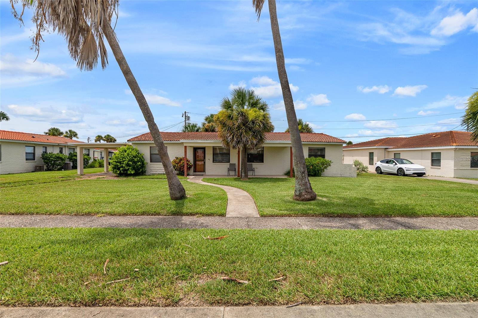 Don't miss this adorable beach bungalow in a seaside Ormond Beach neighborhood. Situated a short walk from the soft sands and rolling ocean waves, this fabulous home brings your beach dreams to life. The beachy home features cute curb appeal and a fabulous floor plan offering 3 bedrooms and 2 bath. The spacious open floor plan boasts a living room, dining area, and a kitchen with eating space and plenty of cabinets. Enjoy added living space with a spacious enclosed Florida room overlooking the back patio. When night falls at the end of a busy beach day, buyers will love retiring to the master suite featuring closet, and ensuite bathroom with walk-in shower. The unit also offers 2 spacious guest bedrooms and an additional full bathroom. The home also boasts a back patio and a carport to keep your car covered on hot days. The community HOA fees cover a sparkling community pool, tennis/pickle ball court, clubhouse, and shuffleboard. And the convenient location of this home is unbeatable, with parks, restaurants, shopping, tourists spots and some of the area's most popular beachside attractions all at your fingertips. Don't delay. This is the beach life you've been searching for.