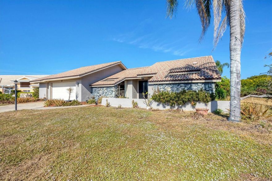 Come on home to the boating community of Englewood isles where you'll find a touch of mid century style blended with luxury design awaiting you in this 3 bedroom 2 bath pool home.  Foyer entry with double doors and tile greets you with luxury vinyl plank flowing  in most areas except bathrooms and laundry room.  Gorgeous walnut wood cabinets some with open shelving including large island and gleaming brightly quartz countertops, will please even the most discriminating cook/entertainer. Primary bedroom has en suite tastefully appointed with dual sinks, walk in shower tiled from floor to ceiling and brick look tile flooring.  Bathroom 2 is equally inviting with tub shower combo that boasts the same tile in shower area and flooring as the primary bath.  Open and spacious living room/dining combo layout with beautiful ship lap vaulted ceiling complemented by faux beams that invite you to come sit and enjoy the ambience.  Your imagination will determine use of "bonus" room with half walls topped with glass walls with grids that elevate the style, perhaps an office or separate dining area?? Y Venture out back to your covered lanai and pool beyond, what more could you ask for?   If your so inclined, the association sells ort rents boat slips if available.  If you appreciate quality and uniqueness this home is a joy to view, not a typical "cookie cutter" layout you see in many communities.  Definitely worth your time to take a look, you'll want to stay!!