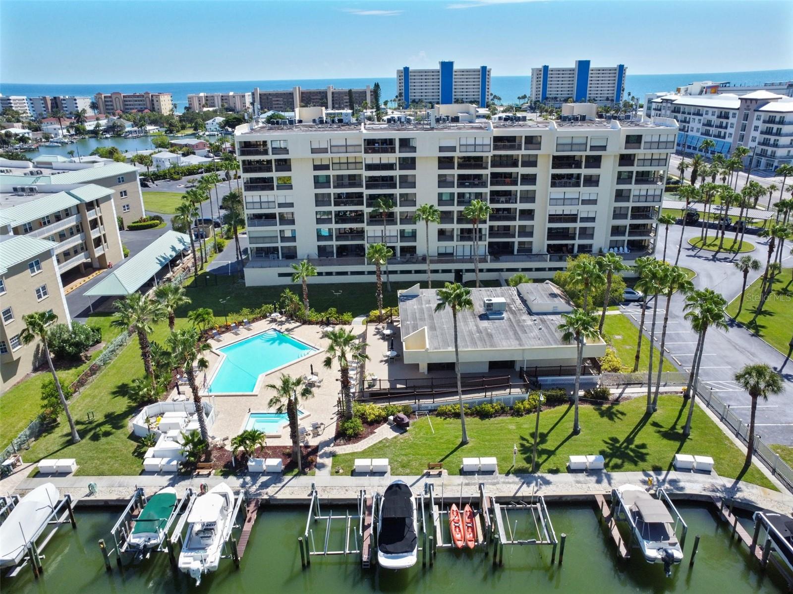 AVAILABLE OCTOBER 2025 - APRIL 2026 - 30 DAY MINIMUM RENTAL. Experience coastal living at its finest in this exquisite, fully furnished 2-bedroom, 2-bathroom condominium, ideally situated on the fourth floor of Boca Vista., this unit offers breathtaking, sparkling views of the Gulf of Mexico, placing you in the heart of the desirable Gulf Beaches. Step onto your private, covered balcony to witness spectacular sunsets over the Gulf, with a picturesque vantage point overlooking the community's heated pool and spa, and the vibrant clubhouse area. In the mornings, this same balcony provides an equally stunning backdrop for sunrises over the Intracoastal Waterway, offering a dual perspective of Florida's natural beauty. The interior of this updated condominium reflects a commitment to comfort and modern style. The gourmet kitchen is a chef's delight, boasting top-of-the-line stainless steel appliances, gleaming granite countertops, and ample storage, including a spacious pantry. A separate closet discreetly houses a newer washer and dryer for added convenience. The expansive master bedroom serves as a serene retreat, featuring a luxurious en suite bathroom equipped with double vanity sinks and abundant closet space, ensuring a private and organized haven. Beyond the unit, Boca Vista offers a wealth of amenities designed for relaxation and recreation. Spend leisurely afternoons by the heated pool, rejuvenate in the spa, or maintain your fitness routine in the clubhouse's well-equipped fitness room. For social gatherings, an outdoor grill area is perfect for entertaining friends and family. Convenience is paramount at Boca Vista. With two covered parking spaces, you'll have peace of mind. The community's central location puts you just steps from the pristine white sand beaches and within easy reach of a variety of shopping destinations, acclaimed restaurants, the American Legion, and the VA Hospital. Please note, for the comfort of all residents, this is a non-smoking unit, and pets are not permitted. Seasonal and off-season rates apply. Come and discover why Boca Vista is the perfect place to make your new home, offering an unparalleled beachgoer's paradise.