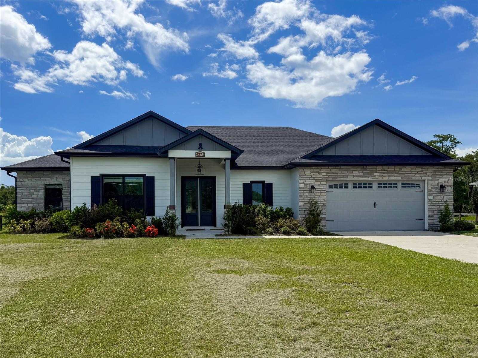 Looking for a brand new home on acreage with NO HOA? Look no further! This custom-built 4 bedroom, 2.5 bathroom home offers 2,582 sq. ft. of thoughtfully designed living space, perfect for a growing family.
The gourmet kitchen is a showstopper, featuring a butler’s pantry, quartz countertops, center island, farmhouse sink, pull-out garbage cabinet, designer backsplash, chimney-style range hood, built-in oven & microwave, and a breakfast bar.
The spacious great room boasts built-in cabinets, custom counters, and an electric fireplace—perfect for cozy evenings. The luxurious master suite includes a tray ceiling, oversized walk-in closet, hardwood floors, a soaker tub, separate shower, dual vanities, and linen cabinets.
Additional upgrades include:
• 5 ¼” baseboards & crown molding
• Ceiling fans throughout
• Double-pane insulated windows
• Rain gutters & 3-panel sliding glass pocket door
• Motion detectors, water softener, & soft-close cabinetry
• Bluetooth speakers in all bathrooms
• TV hookup on the back patio
This home is built with concrete block, gable board, and Hardie board siding for long-lasting durability. Hardwood floors flow throughout the home, with carpet in three bedrooms. Lot dimensions are approximately 110’ x 593’ x 110’ x 597’, offering plenty of space for outdoor enjoyment.