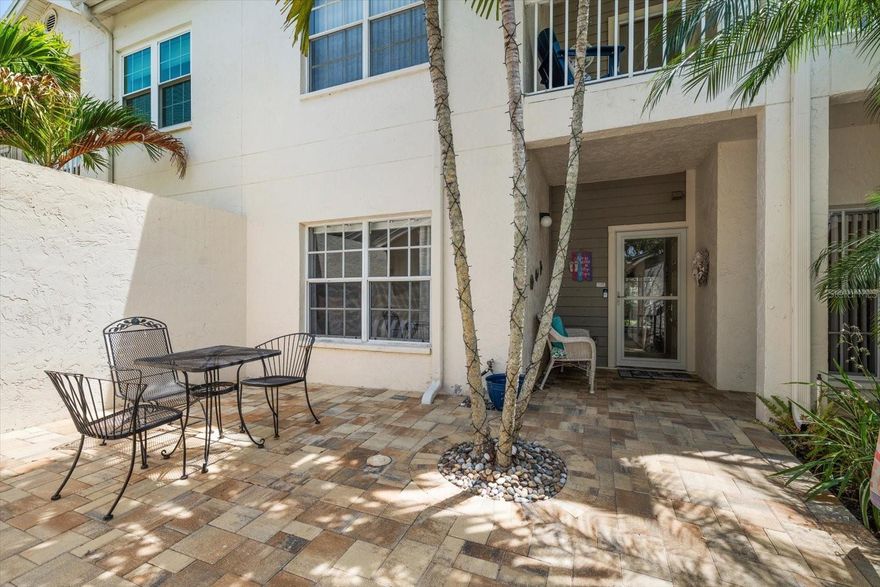 Tucked away on a quiet, tree-lined cul-de-sac, this exceptionally private ground-floor corner residence offers a rare blend of comfort, style, and convenience—complete with a deeded one-car garage. The approach to this home is as inviting as the home itself, featuring a brick driveway, a charming brick paver courtyard with tropical palm trees, and a welcoming covered front porch.
Step inside to a beautifully remodeled 2-bedroom, 2-bath home where an open, airy layout and soft coastal palette create a relaxed, beach-inspired feel. Natural light pours in through oversized windows, enhancing the bright and welcoming living spaces.
The updated kitchen is both stylish and functional, featuring expansive windows, granite countertops, a tile backsplash, soft-close cabinetry, and a dedicated coffee bar. A single-level breakfast bar with pendant light and seating opens seamlessly to the dining and great room, making everyday living and entertaining effortless. Stainless steel appliances (2021) complete the space.
The kitchen flows seamlessly into the dining area and spacious great room, where serene backyard views create a peaceful backdrop. Sliding glass doors lead to a screened, covered lanai—perfect for morning coffee or evening relaxation—and extends out to a Trex sun deck designed for grilling, entertaining, and gathering with friends, all set within a remarkably private, tranquil outdoor setting.
The split-bedroom floor plan offers comfort and privacy, with a spacious primary suite and a well-appointed guest bedroom and bath, ideal for visitors or flexible use.
The spacious primary suite is your personal retreat, offering lanai access through sliding glass doors and large windows that frame peaceful, private views. The updated en suite bath features a generously sized custom walk-in closet, granite countertops with dual sinks, soft-close cabinetry, a tile and glass walk-in shower, and a private water closet.
The guest bedroom, complete with a custom closet, is a welcoming space ideal for guests or family, with convenient access to the fully updated hall bath featuring a tile and glass walk-in shower. A centrally located laundry closet adds everyday ease and functionality.
A private one-car garage completes the many outstanding features of this residence, offering a garage door opener and pull-down stairs for convenient attic storage.
Located within the gated 56-acre Shipwatch Yacht & Tennis 
This pet-friendly, waterfront resort community offers outstanding amenities including two pools (one heated), two clubhouses—one with a full kitchen and waterfront deck—a 45-slip private marina for residents (subject to availability) with electricity, water, ice, and guest parking. Scenic walking and biking trails, fitness center, hot tub, BBQ grills, car wash, 11 of the best Har-Tru tennis courts in the county with pro shop, viewing stands, on-site tennis pro, massage therapist, and two pickleball courts are also available to owners.
Lounge by the Olympic-size waterfront pool, play Pickleball, Shuffleboard, Horseshoes or enjoy the abundant nature throughout the community’s walking and biking trails. Perfect for tennis and pickleball enthusiasts, boaters, and beach lovers alike, this exceptional property is just a short walk over the bridge to Indian Rocks Beach’s many beach restaurants and shops, Splash Harbor Water Park, and the sparkling waters of the Gulf of America. Enjoy the Florida resort lifestyle! NOT IN A FLOOD ZONE
