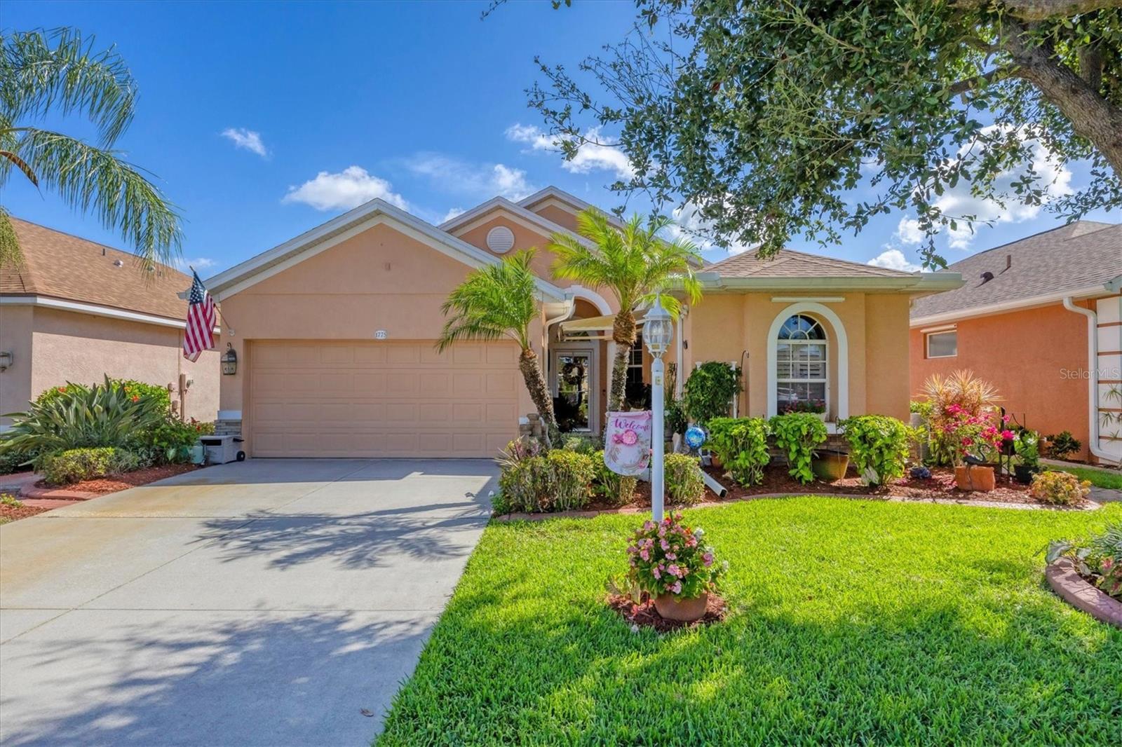 This exceptionally maintained 3 bedroom, 2 bath home with a 2 car garage offers over 1,700 square feet of comfortable living space, combining thoughtful upgrades, stylish finishes, and one of the best views in the neighborhood. Built in 2005 and meticulously cared for, this home is truly move-in ready. From the moment you arrive, you'll notice the beautiful landscaping and curb appeal, setting the tone for what awaits inside. Step through the front door into a spacious, open-concept layout filled with natural light and upgraded finishes. Tile flooring flows through the main living areas, while the bedrooms feature luxury vinyl plank flooring for a warm, modern touch. The upgraded kitchen features solid wood cabinetry, granite countertops, a granite composite sink, and a large breakfast bar that is ideal for casual dining or entertaining. You'll love the pull-out drawers in both the pantry and cabinets for extra organization. A full appliance package is included: natural gas stove, refrigerator, dishwasher, microwave, and a wine fridge for your favorite vintages. Plantation shutters add a touch of elegance throughout the home, and decorative lighting and ceiling fans complement the design. The split-bedroom layout offers privacy for family and guests. The oversized primary suite features a tray ceiling with crown molding, and a luxurious en-suite bath with a large walk-in shower, dual sink vanity with granite counters, two walk-in closets, and a linen closet. Step outside to the extended screened lanai, a true outdoor oasis. This incredible space includes upgraded tile flooring, a built-in grill, hot tub, electric retractable awnings, and plenty of room to relax or entertain all while enjoying gorgeous lake views with TWO lakes visible. There’s also a separate enclosed lanai area perfect for a cozy sitting space or additional lounge area. Additional features include a tank-less natural gas water heater (2022), Mini-split A/C in the garage for climate-controlled storage or workshop space, Garage freezer included, Hurricane protection including electric roll-down shutters on the back and Kevlar panels on the sides and panels for the front of the home. The lanai TV, fireplace, outdoor grill, and golf cart stay! Roof was replaced in 2022. For added peace of mind, this home is not located in a flood zone – no flood insurance is required. Enjoy all the benefits of maintenance-free living with a low HOA fee of just $286 per quarter, which covers lawn care. Lakeside Plantation is a welcoming, amenity-rich community with features such as a clubhouse, fitness center, pool and spa, tennis courts, pickleball, playground, and social events for all ages. You'll be less than 30 miles from award-winning Gulf of Mexico beaches and just a few miles from I-75, local shopping, golf courses, and entertainment. Downtown Wellen Park and the new Atlanta Braves Stadium are only 20 minutes away. Don't miss your opportunity to own this incredible home with top-tier upgrades, lake views, and resort-style outdoor living—schedule your private showing today!