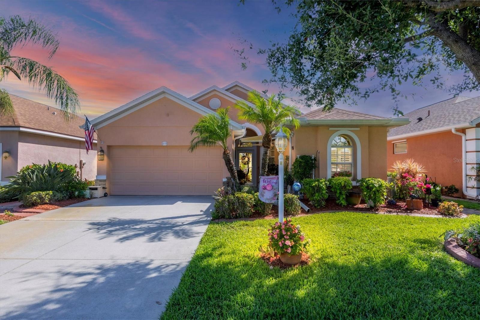 This exceptionally maintained 3 bedroom, 2 bath home with a 2 car garage offers over 1,700 square feet of comfortable living space, combining thoughtful upgrades, stylish finishes, and one of the best views in the neighborhood. Built in 2005 and meticulously cared for, this home is truly move-in ready. From the moment you arrive, you'll notice the beautiful landscaping and curb appeal, setting the tone for what awaits inside. Step through the front door into a spacious, open-concept layout filled with natural light and upgraded finishes. Tile flooring flows through the main living areas, while the bedrooms feature luxury vinyl plank flooring for a warm, modern touch. The upgraded kitchen features solid wood cabinetry, granite countertops, a granite composite sink, and a large breakfast bar that is ideal for casual dining or entertaining. You'll love the pull-out drawers in both the pantry and cabinets for extra organization. A full appliance package is included: natural gas stove, refrigerator, dishwasher, microwave, and a wine fridge for your favorite vintages. Plantation shutters add a touch of elegance throughout the home, and decorative lighting and ceiling fans complement the design. The split-bedroom layout offers privacy for family and guests. The oversized primary suite features a tray ceiling with crown molding, and a luxurious en-suite bath with a large walk-in shower, dual sink vanity with granite counters, two walk-in closets, and a linen closet. Step outside to the extended screened lanai, a true outdoor oasis. This incredible space includes upgraded tile flooring, a built-in grill, hot tub, electric retractable awnings, and plenty of room to relax or entertain all while enjoying gorgeous lake views with TWO lakes visible. There’s also a separate enclosed lanai area perfect for a cozy sitting space or additional lounge area. Additional features include a tank-less natural gas water heater (2022), Mini-split A/C in the garage for climate-controlled storage or workshop space, Garage freezer included, Hurricane protection including electric roll-down shutters on the back and Kevlar panels on the sides and panels for the front of the home. Some furnishings are negotiable. The lanai TV, fireplace, outdoor grill, and golf cart stay! Roof was replaced in 2022. For added peace of mind, this home is not located in a flood zone – no flood insurance is required. Enjoy all the benefits of maintenance-free living with a low HOA fee of just $286 per quarter, which covers lawn care. Lakeside Plantation is a welcoming, amenity-rich community with features such as a clubhouse, fitness center, pool and spa, tennis courts, pickleball, playground, and social events for all ages. You'll be less than 30 miles from award-winning Gulf of Mexico beaches and just a few miles from I-75, local shopping, golf courses, and entertainment. Downtown Wellen Park and the new Atlanta Braves Stadium are only 20 minutes away. Don't miss your opportunity to own this incredible home with top-tier upgrades, lake views, and resort-style outdoor living—schedule your private showing today!