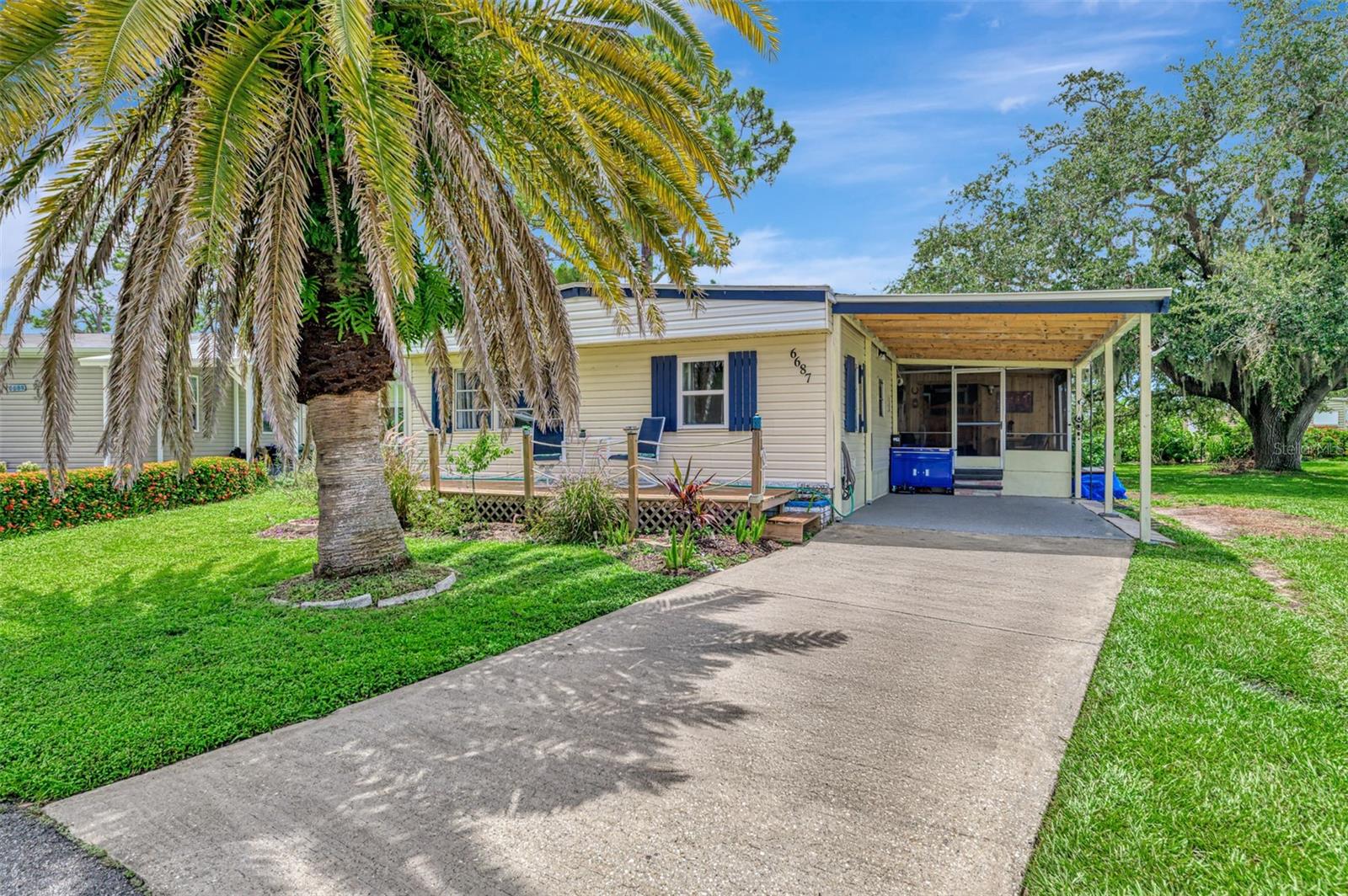 Located in the 55 plus Community of Holiday Park where you are sure to find plenty to do while enjoying your peaceful lifestyle. If you would love to live in the country but prefer the convivence of living in the city this home may just be the right place for you! This spacious three-bedroom, two full bath home with a country / western style flare with vinyl flooring throughout offers an open concept for the main living space. Kitchen is equipped with ample newer cabinetry with hardware, plenty of countertop space as well, center island with breakfast bar, newer stainless-steel appliances (2021), large dining area, open to the generous size living room. Sellers have created the look of beams in the ceiling, added cedar wood to one wall in the living room and have decor to add to the country style. The three bedrooms are of all nice space and plenty of closet space. There is a screened in porch for relaxing any time of day walk through the saloon doors to where the hot tub is located which is (negotiable) and for the handyman person workshop with storage!! This home sits on a Cul de Sac with nice size yard, mature trees, freshly painted carport drive. Holiday Park offers two swimming pools, tennis and pickleball courts, Recreation Center, work out room, library, ping pong, card playing, dance events, picnics, lawn maintenance, and more! Sellers will also provide the generator and Golf Cart to the new owners! Another great feature of owning a home in Holiday Park is you own the land you have an actual deed, your maintenance fee of $195.00 a month $2340.00 a year is included your tax amount!! Now is the time to schedule to see your piece of the country in the city!