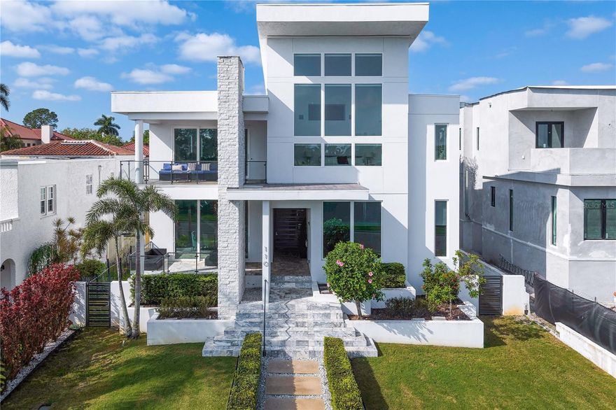 A modern architectural residence designed for seamless indoor-outdoor entertaining.
Perfectly positioned in the coveted enclave of Snell Isle and overlooking the ninth hole of the
prestigious Vinoy Golf Course, this exceptional custom residence offers a rare blend of modern
architecture, enduring construction, and sweeping golf course vistas.
Completed in 2018, the home features solid concrete construction and is elevated above the flood
zone. Encompassing over 4,300 square feet, the residence includes 4 bedrooms, 4.5 bathrooms, a
private elevator, and an oversized 3-car garage, each element thoughtfully curated to deliver
both sophistication and livability.
Designed with entertaining in mind, the open concept layout is defined by soaring ceilings and
expansive, light-filled interiors that create an immediate sense of scale and flow. Pocketing
hurricane-impact glass doors dissolve the boundary between indoors and out, revealing
uninterrupted fairway views and extending the living experience to multiple terraced gathering
spaces.
The kitchen and butler’s pantry are equally impressive, featuring high-end appliances including a
gas range, dual refrigerators, two dishwashers, and double convection oven, complemented by
sleek custom lacquer cabinetry and abundant storage. Seamlessly integrated into the main living
areas, the space is ideally suited for both everyday living and elevated entertaining.
The primary suite is a private sanctuary, defined by dramatic ceiling lines, panoramic golf course
views, and a striking two-story custom closet. The spa-like bath offers dual vanities, a walk-in
shower, and a separate soaking tub, creating a calm and restorative environment.
Each guest suite is generously proportioned and appointed with its own en suite bath. A standout
feature of the home is the private, casita-style main-level suite, ideally positioned poolside with
its own separate entrance, perfect for hosting guests or extended stays while offering a
heightened sense of privacy.
Upstairs, a loft-style bonus area is artfully separated by a floating staircase, serving as a striking
architectural focal point while creating a distinctly versatile space ideal for a media room, office,
or lounge.
Outdoor living is equally well considered. A fully equipped outdoor kitchen anchors the space,
while expansive terraces, a covered lanai, and an elevated saltwater pool create a private, resort-
style setting designed for both entertaining and relaxation.
The oversized 3-car garage is fully finished with a polished floor and floor-to-ceiling custom
cabinetry, offering exceptional storage and a refined extension of the home.
Ideally located just minutes from downtown St. Petersburg’s acclaimed dining, museums, and
waterfront, and within convenient reach of Tampa International Airport, this residence presents a
compelling opportunity to own a newer, architecturally significant home in one of the area’s
most desirable neighborhoods.