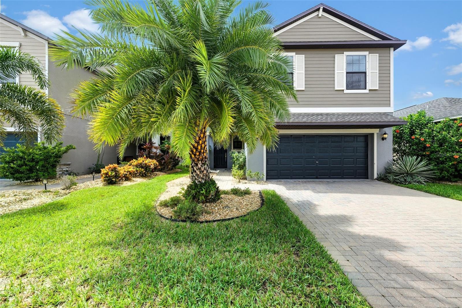 Welcome to this stunning home in the highly desirable Belmont community, offering modern living with energy efficiency and resort-style amenities. From the moment you arrive, the paver driveway and covered front porch create a warm and inviting curb appeal. Inside, soaring ceilings and an open-concept layout seamlessly connect the living, dining, and kitchen areas, perfect for entertaining and everyday living. The chef’s kitchen is a true showpiece with 42" espresso cabinetry, crown molding, granite countertops, a large island, stainless steel appliances, and a walk-in pantry. Upstairs, a versatile loft separates the spacious secondary bedrooms from the luxurious master suite, which features dual granite sinks, a garden tub, walk-in shower, and walk-in closet. The screened lanai overlooks a tranquil pond view with fruit trees and a fully fenced backyard, making it the perfect place to relax or entertain outdoors. Additional upgrades include a fully paid-off solar panel system, Nest thermostat, an invisible cable management system, Vivint security system, and extra garage storage for comfort and peace of mind. Belmont residents enjoy resort-style pools, tennis and basketball courts, dog parks, scenic walking and biking trails, fishing ponds, and close proximity to Publix, shopping, dining, and nearby beaches. This home is move-in ready and designed with both style and functionality in mind—don’t miss your chance to make it yours!