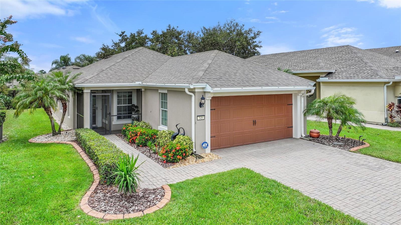 Pristine move-in condition 3/2 Riviera model in Del Webb Orlando's Vista Grande community with 2024 HVAC, 2021 Roof and 2020 Generac 22 kW Whole-House Generator has solid-surface floors throughout and is available to close on or after 10/15/2025. Screened front porch with full-view storm door opens to a bright and cheery central living area flanked by 3 bedrooms, a generous eat-in kitchen and an oversized south-facing screened lanai with adjacent patio. Newer stainless-steel kitchen appliances include a 5-burner natural gas stove. Triple patio doors to lanai from primary en suite bedroom with walk-in closet and updated full bath. Newer ceiling fans, COR thermostat and recessed lighting. Titan floors in garage, screened lanai and on patio. Ceiling-mounted storage and shelving unit in garage with Titan floor. Freezer in garage is reserved. Natural gas and electric dryer hookups in laundry closet. Existing dryer is powered by electricity. Mature landscaping inside custom cement shrub bed curbing with mulch & river rock. Partial seamless gutters. Owned ADT security system equipment. Actively managed Sentricon pest control system. Select furnishings available for sale separately. Sold As-Is. Ridgewood Lakes is a golf cart friendly community. $352 monthly Del Webb Orlando HOA fee provides lawn cutting and shrub bed trimming + exclusive access to the HOA-owned 30,000 SF Montecito clubhouse with indoor & outdoor heated pools, hot tub, fitness center, walking track and pub. Pickle ball, bocce and tennis courts, dog parks and sidewalks. $425 semi-annual Ridgewood Lakes HOA fee provides 24x7 staffed security gate and master association-owned private road maintenance. Del Webb Orlando is a 55+ community with full-time lifestyle directors, located in Ridgewood Lakes gated community with miles of walking & biking trails and adjacent to 18-hole White Heron Golf Club, privately owned and open to the public. Shopping, Disney & Central Florida entertainment nearby, easy access to I-4, medical facilities, airports and Sunrail Station. Advent Health hospital 3 miles away.
