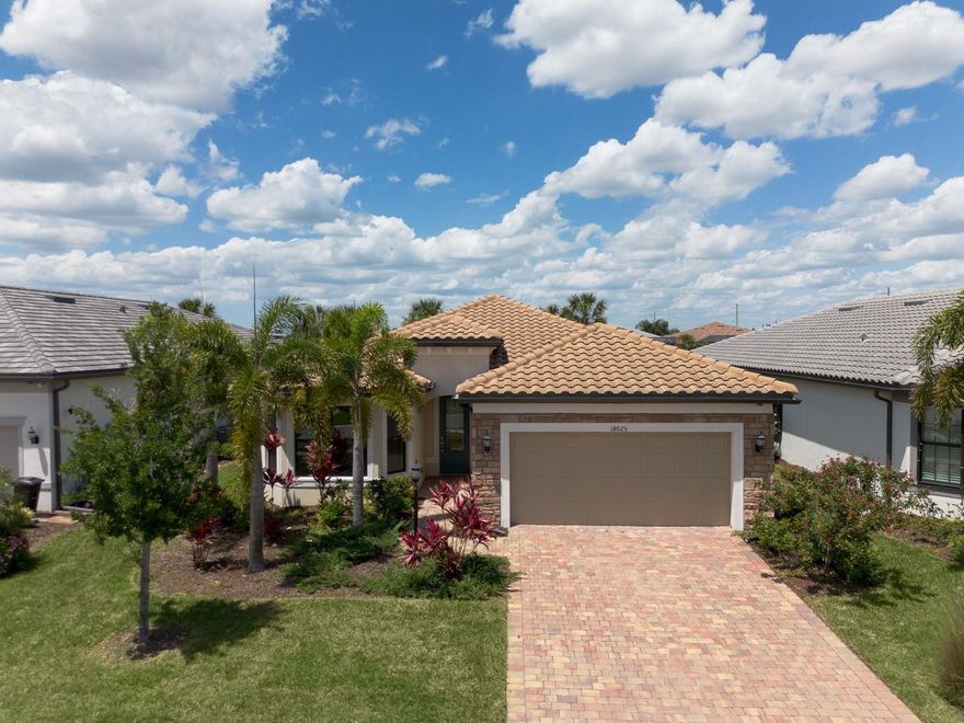 One or more photo(s) has been virtually staged. Experience the pinnacle of Florida resort living in this stunning, nearly-new Mystique Model located on a quiet cul-de-sac in the prestigious Del Webb Lakewood Ranch. Built in December 2022 and meticulously maintained with only occasional visits, this residence offers 2,128 sq. ft. of pristine, move-in-ready luxury.

From the moment you arrive, the upgraded stone facade and decorative glass front door provide exceptional curb appeal. Step inside to find an interior defined by elegance and volume, rounded corner interior walls, featuring 8-foot interior doors and crown molding throughout the entry, den, dining area, gathering room, and all bedrooms. The flooring is a sophisticated blend of luxury vinyl plank in a light, warm wood tone and large neutral beige tile set on a diagonal for a custom, high-end feel.

This rare configuration is a standout in the community, offering 3 bedrooms and 3 bathrooms, plus a versatile office/den. The gourmet Chef’s Kitchen is a culinary masterpiece, featuring 42” white cabinetry with soft-close drawers, a custom wood hood vent, and solid surface countertops. The space is tied together with a decorative full-tile backsplash, a built-in oven and microwave, a gas cooktop, and a premium KitchenAid appliance package.

The gathering room serves as the heart of the home, featuring zero-corner pocket sliding doors that disappear to create a seamless transition to your outdoor oasis. Step out onto the expanded lanai to enjoy your private saltwater pool with a gas heater and a bronze enclosure, all overlooking a serene water view. The lanai is fully prepared for your dream outdoor lifestyle with pre-plumbing for a summer kitchen (water, gas, and vent) and pre-wiring for television.

The Owner’s Suite is a peaceful retreat boasting a tray ceiling with crown molding and a spa-like ensuite. The frameless glass shower features neutral tile to the ceiling, a built-in niche, a bench, and a window for natural light. Two additional guest rooms—one featuring a charming bay window—and two additional full baths ensure plenty of space for family or visitors.

Practicality meets luxury in the laundry room, which is fully equipped with cabinets on both sides and a sink. The 2-car garage features an epoxy floor coating and a Wi-fi-enabled opener.

Why wait for a new build when you can own this upgraded, never-lived-in masterpiece today? Located in the heart of Lakewood Ranch, the nation’s #1 multi-generational community, you are minutes away from world-class dining, shopping, and the exclusive amenities of Del Webb. Schedule your private showing today!
