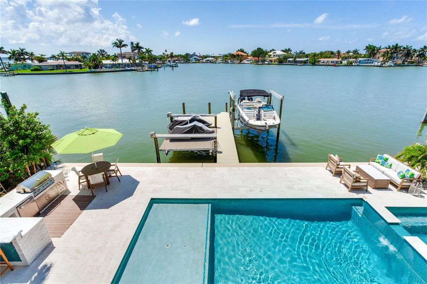 ELEGANT WATERFRONT ESTATE | 5 BEDROOMS • 5 BATHS • 3,767 SQ FT
Experience the wow factor from the moment you enter this fully renovated North Redington Beach estate. This 5-bedroom, 5-bath tropical oasis offers an open, airy floor plan with soaring ceilings and stunning water views. The chef’s kitchen is a dream, featuring granite countertops, stainless steel appliances, a spacious island with abundant storage, and a pass-through breakfast bar—perfect for family gatherings or entertaining on a grand scale. The main level offers two bedrooms with ensuite baths, plus a third guest room with access to a full bath. Upstairs, a second living space takes in panoramic Boca Ciega Bay views from a frameless glass balcony. The luxurious primary suite is an oversized retreat with a spa-inspired ensuite featuring a soaking tub, walk-in glass shower, and dual vanities. An additional guest suite and full bath complete the upper level. Step outside to your private resort-style paradise. Enjoy a brand-new pool with sun shelf and spa, an outdoor kitchen, and lush tropical landscaping. A new seawall and dock include a 12,000 lb lift plus a flat lift for jet skis or other water toys. Every detail of this home reflects craftsmanship, beauty, and the ultimate Florida lifestyle. Don’t miss this opportunity to own one of the area’s premier waterfront residences.