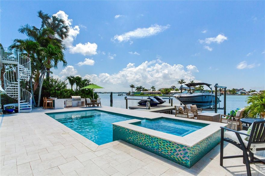 ELEGANT WATERFRONT ESTATE | 5 BEDROOMS • 5 BATHS • 3,767 SQ FT
Experience the wow factor from the moment you enter this fully renovated North Redington Beach estate. This 5-bedroom, 5-bath tropical oasis offers an open, airy floor plan with soaring ceilings and stunning water views. The chef’s kitchen is a dream, featuring granite countertops, stainless steel appliances, a spacious island with abundant storage, and a pass-through breakfast bar—perfect for family gatherings or entertaining on a grand scale. The main level offers two bedrooms with ensuite baths, plus a third guest room with access to a full bath. Upstairs, a second living space takes in panoramic Boca Ciega Bay views from a frameless glass balcony. The luxurious primary suite is an oversized retreat with a spa-inspired ensuite featuring a soaking tub, walk-in glass shower, and dual vanities. An additional guest suite and full bath complete the upper level. Step outside to your private resort-style paradise. Enjoy a brand-new pool with sun shelf and spa, an outdoor kitchen, and lush tropical landscaping. A new seawall and dock include a 12,000 lb lift plus a flat lift for jet skis or other water toys. Every detail of this home reflects craftsmanship, beauty, and the ultimate Florida lifestyle. Don’t miss this opportunity to own one of the area’s premier waterfront residences.