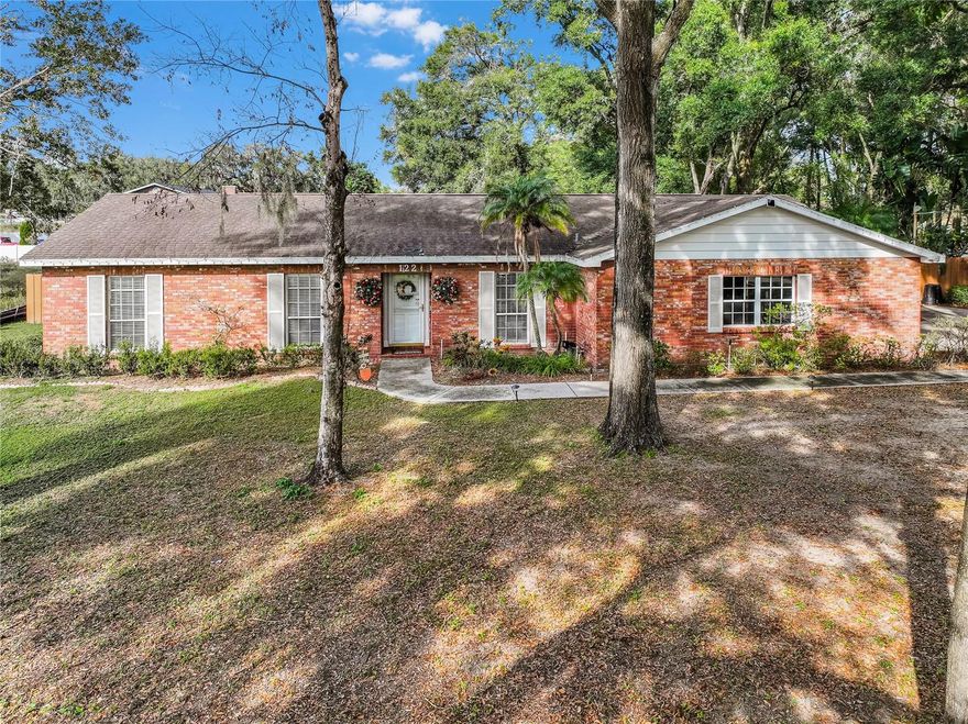 Welcome to your new home on Cactus Rd, a meticulously maintained 2-bedroom, 2-bathroom residence situated on an expansive HALF-ACRE lot in the quiet and centrally located neighborhood of Seffner! Upon entering, natural light floods the interior accentuating the NEW flooring (2023) throughout the home.  To the immediate right, the glass French doors lead to the Bonus Room/Office.  This versatile space seamlessly connects with the entire home and could effortlessly be transformed into a 3rd bedroom. The recently updated kitchen (2023) is a culinary haven, boasting NEW quartz counters (2023), an exquisite herringbone-style backsplash (2023), a NEW oversized kitchen island (2023), and NEW cabinets with a pantry (2023). The kitchen flows openly into the spacious living room with custom-built shelving, perfect for entertaining or just relaxing.  The spacious dining area, complete with a built-in bar (2023) and two storage closets, fulfilling your storage dreams.  The kitchen and dining area overlooks the tranquil backyard and fire pit. The primary bedroom, located at the far right end of the home, features high ceilings, ample natural light, a built-in closet, and an additional walk-in closet with built-in cabinets. The en-suite bathroom is adorned with a granite countertop, a shower enclosure, and linen closet storage. On the opposite far left end of the home, the guest bedroom is bathed in natural light, equipped with plantation shutters, 2 large built-in closets, and strategically located with access to the guest bathroom—ideal for a multigenerational family or out-of-town guests. Step outside to your private retreat, where the expansive outdoor space includes a covered and screened-in patio, perfect for entertaining or relaxing while enjoying the lush backyard greenery. Conveniently located across from Seffner Elementary School, YMCA, and the local fire station, with easy access to restaurants, shopping, entertainment, Tampa, Lakeland, and USF. This incredible home comes with NO HOA OR CDD FEES. With its modern design, thoughtful renovations, and prime location, this property is a true gem. Don't miss the chance to call this house your home—schedule your showing today!