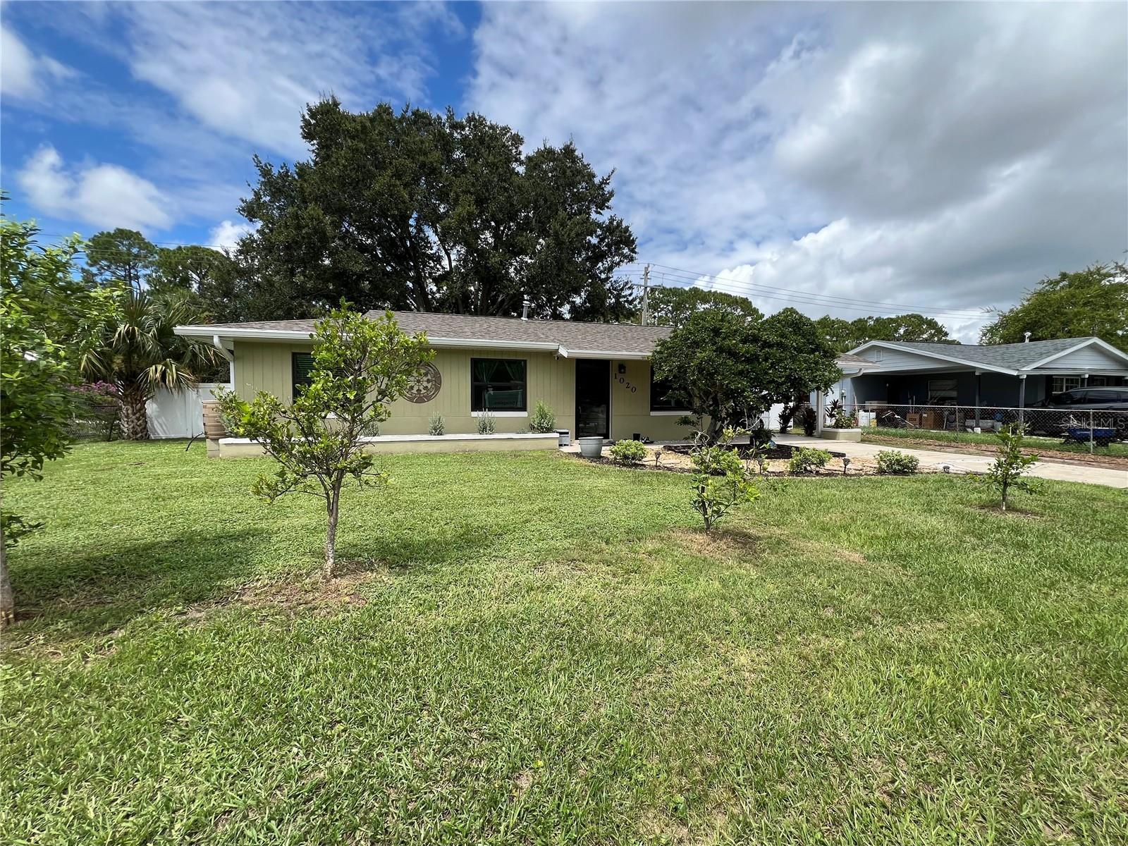 Beautifully Maintained Home in Daytona Beach! Welcome to this move-in ready 3-bedroom, 2-bath concrete block home featuring modern upgrades and timeless charm. Step inside to find porcelain tile flooring throughout, a spacious open layout, and new appliances that make everyday living a breeze. Enjoy peace of mind with a New AC, a 5-year-old roof, gutters with downspouts, and Cat 5 hurricane impact windows for maximum protection. Outdoors, the home shines with lush landscaping, fruit trees, and a huge fenced backyard—perfect for kids, pets, and entertaining. Relax year-round in the screened-in patio, or take advantage of the close proximity to shopping, restaurants, the airport, and all that Daytona Beach has to offer. This home combines comfort, security, and convenience. Don’t miss your chance to own it!