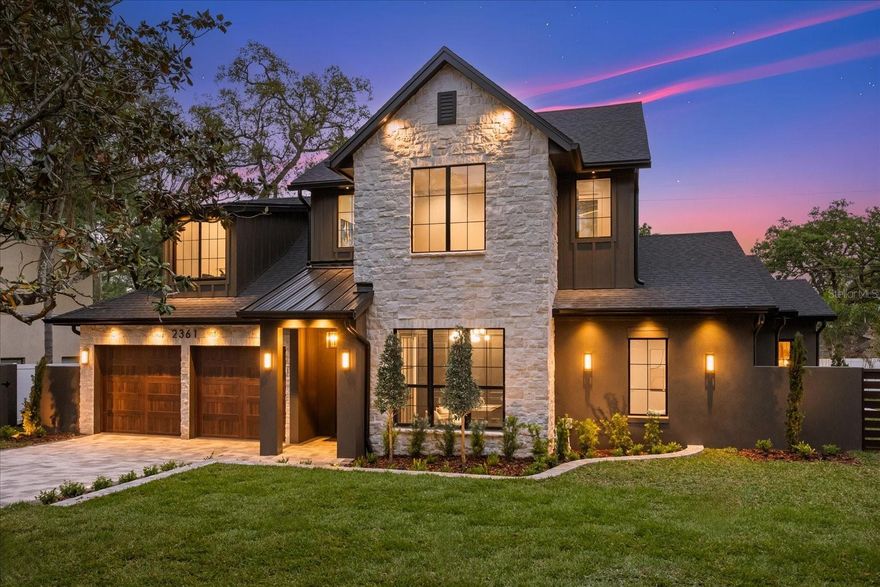 Casa Noir — Brand new construction custom home selected as a 2026 Parade of Homes showcase in Winter Park, and from the street alone, it is not difficult to understand why. 4 bedrooms. 4 full baths. Dedicated office. Loft. 2-car garage. Just under 3,200 sq ft. Custom finishes done to perfection throughout. Inside, the foyer delivers on every promise made at the curb — soaring exposed oak beams, cascading brass pendants, and a sculpted arched alcove. Warm white oak wood floors begin here and do not stop. Anchoring the great room, the fireplace rises floor to ceiling in natural stone, with the kind of presence that makes everything else arrange itself around it. Custom oak built-ins with backlit shelving flank the space. At the far wall, a glass slider opens the room entirely to the pool beyond — where indoor and outdoor living become one. The kitchen is a destination. Custom white oak cabinetry climbs every wall to the ceiling. A full-height illuminated wine rack column. Glass-front uppers. The quartz island stretches across the heart of the room, dressed in brass pendants above and brass hardware at every pull — wide enough to host and intimate enough to linger. A Thor 48-inch gas range commands the room beneath a custom cabinet hood with integrated storage. A walk-in pantry connects both. Dining — connected, but defined. A sculptural alabaster chandelier hangs above a backlit arched niche. Easy for everyday. Elevated for hosting. Mudroom with a floating oak bench. Laundry finished in sage green cabinetry, quartz counters, and a matte black sink. Then the primary suite — and Casa Noir reaches its second act. An oak beam tray ceiling. A crystal chandelier on a brass canopy. The bath features floor-to-ceiling stone tile, a freestanding soaking tub, dual brass shower heads, and two independent floating fluted oak vanities, LED-lit at the base. The walk-in closet completes the space — floor-to-ceiling shelving, double hanging zones, and a built-in window seat. The office features moody charcoal walls, exposed oak beams, full-height wainscoting, steel-and-glass double doors, and a walk-in closet that allows it to function as a fifth bedroom when needed. The pool bath includes a fluted oak vanity with LED base lighting, terrazzo flooring, a ribbed tile shower, frameless glass, and brass throughout. Upstairs, a black steel staircase beneath a cascading glass disc chandelier leads to the loft. Three bedrooms follow — the ensuite finished in designer teal mosaic tile with brass fixtures and a frameless glass shower; the remaining two share a Jack-and-Jill bath with dual oak vanities, a herringbone tub surround, and brass throughout. Outside, a tongue-and-groove covered lanai anchors a fully built-in outdoor kitchen. Pavers lead to a crystal blue pool — a spa-resort setting that makes every weekend feel like a getaway without leaving home. Zoned for top-rated Audubon Park K-8 and Winter Park High School. Prime Winter Park location — minutes to Park Avenue, Rollins College, and more. Schedule your showing today.