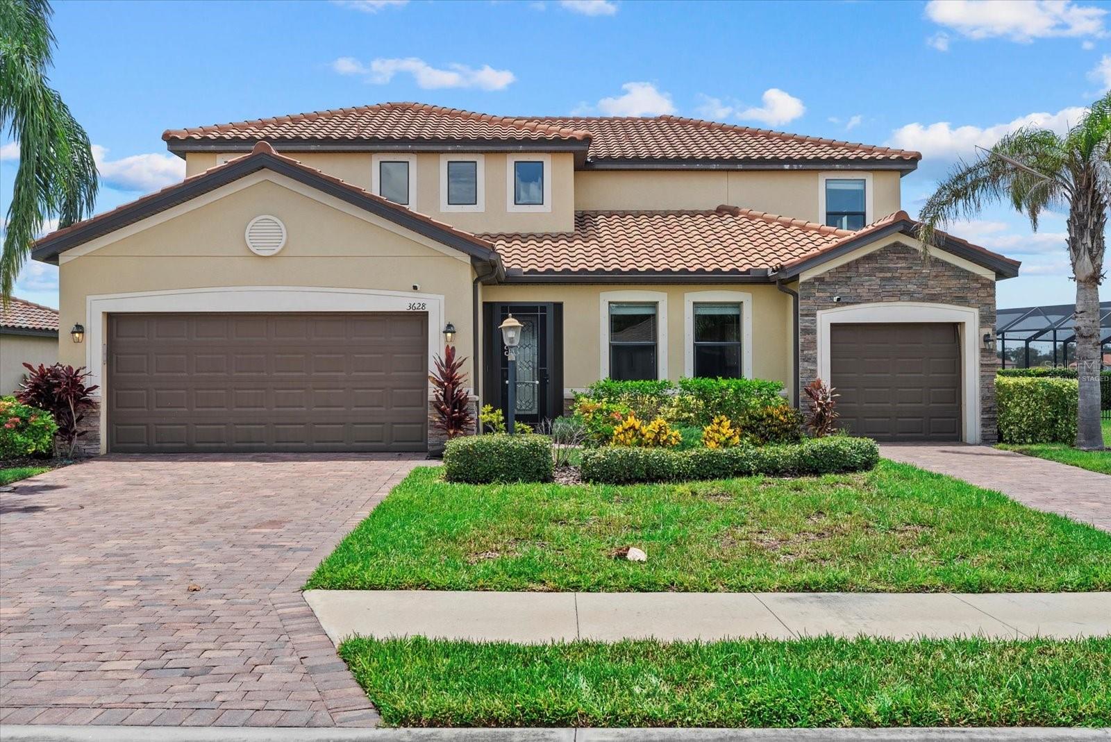 One or more photo(s) has been virtually staged. Experience the ultimate in multigenerational living with this 2018 Lennar Liberation model in Lakewood Ranch’s gated Savanna community—featuring a rare attached in-law suite, breathtaking lake views, and up to $20,000 in seller-paid closing costs.
This is your chance to own a rare multigenerational home in the highly sought-after, maintenance-free community. Thoughtfully designed for versatility and comfort, offering a total of 6 bedrooms and multiple living spaces to fit your lifestyle.
The main home features 5 bedrooms upstairs, including the owner’s suite, and a generous open-concept layout on the first floor with lake views, a formal dining room, and a chef’s kitchen. The kitchen boasts a central island with counter-height seating, pendant lighting, white cabinetry, stone countertops, stainless-steel appliances, and an adjacent casual dining area. Upgraded finishes are found throughout, including tile flooring laid on the diagonal, crown molding, modern lighting, and neutral color tones.
An attached in-law suite on the main level provides privacy and convenience with its own single-car garage, kitchen, laundry, walk-in closet, full bathroom, and private exterior entrance. This flexible space is ideal for extended family, long-term guests, a home office with separate entry, or potential rental income.
Savanna is a gated community offering residents a clubhouse, resort-style pool, fitness center, playground, basketball court, and dog park, along with included lawn and landscape maintenance. Lakewood Ranch, recognized as one of the nation’s top master-planned communities, provides A-rated schools, abundant parks, shopping, dining, and easy access to Gulf Coast beaches.
As an added bonus, the sellers are offering up to $20,000 toward buyer closing costs with an acceptable offer. Schedule your private showing today while this home lasts.