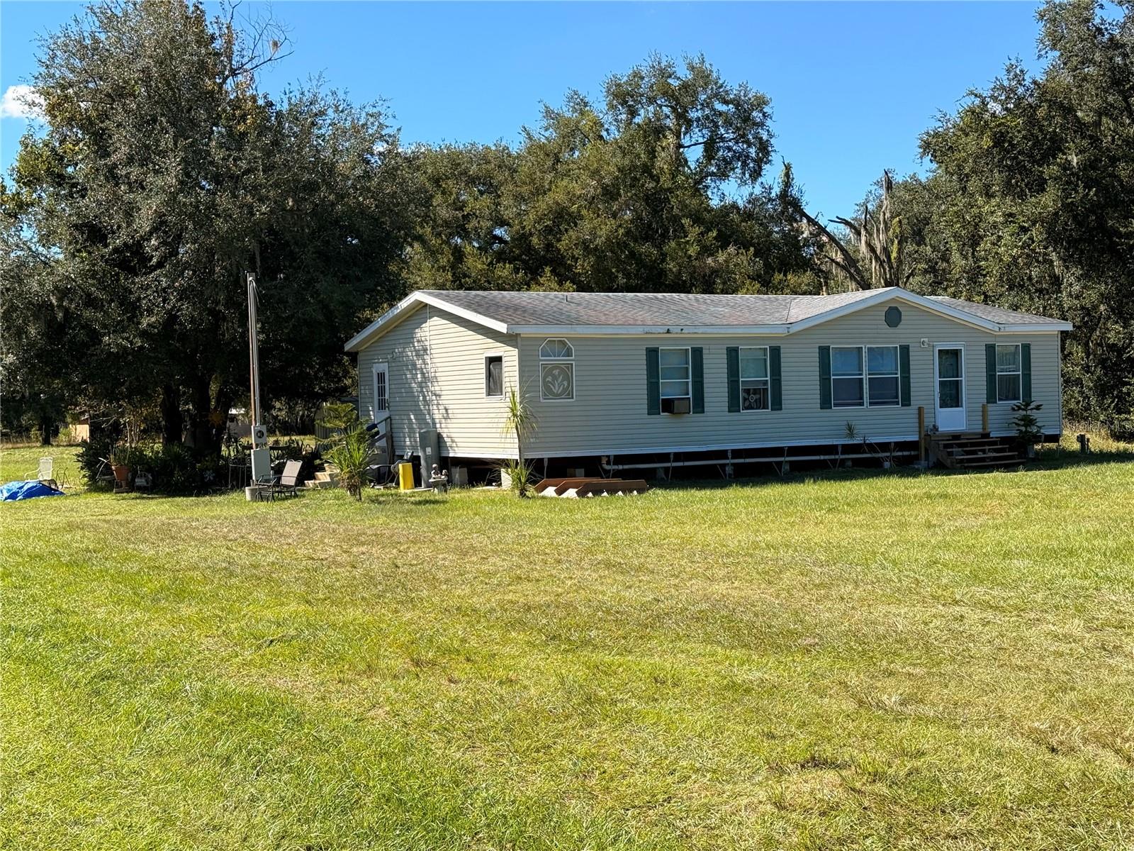 Nestled on 5 serene acres, this exceptional property offers both space and versatility in a prime location. Featuring two doublewide mobile homes, it's ideal for multi-generational living, rental income, or a private guest retreat. Each home provides comfortable living areas, a kitchen, and an open floor plan. The second home features a small barn; a shed; and a fence in area for pets. The land itself offers endless potential-perfect for gardening, livestock, or building your dream home (county approval)-all while enjoying the peace of rural living with convenient access to nearby shopping, schools, and major highways. Whether you're seeking an investment opportunity or a quiet personal haven, this property combines comfort, convenience, and country charm. Located just South of the industrial area on County Line Rd.