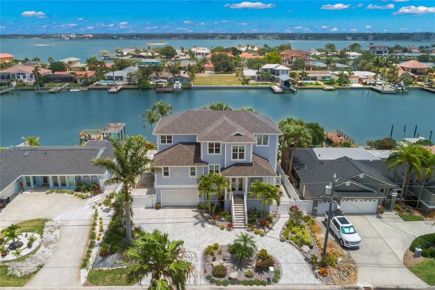 300K PRICE ADJUSTMENT on this 2017 CUSTOM-BUILT WATERFRONT HOME located in the boating community of Island Estates in the award-winning Clearwater Beach. This exceptional residence on DEEP WATER AND WIDE CANAL sets a new standard for opulent WATERFRONT LIVING. With its HIGH QUALITY SOLID BLOCK CONSTRUCTION with 41 PILINGS that are driven 35 feet into the bedrock for a STRONG FONDATION. COMMERCIAL GRADE 3 story reinforced CONCRETE BLOCK CONSTRUCTION with OVER $200K IN HIGH IMPACT HURRICAINE WINDOWS AND SLIDERS for not only beauty but peace of mind in all weather conditions. BUILT TO CURRENT FEMA STANDARDS. Homeowner ONLY PAYS $3,700 ANNUALLY FOR INSURANCE saving you many thousands of dollars each year. Designed with pleasure, safety & convenience in mind, this home boasts an array of exceptional features & TOP OF THE LINE CRAFTMANSHIP, including an ELEVATOR. Ground floor features a spacious 4-CAR TANDEM GARAGE PLUS approx 1500 SF of Air conditioned versatile space (not counted in total SF) that could serve as a LARGE GAME ROOM or workshop & offers plenty of storage space. Every room in this exquisite home offers BREATHTAKING WATER VIEWS from the main living area & kitchen to the great room. The open-concept main living floor boasts SOARING 20 FT CEILNGS, allowing natural light to flood the space. NATURAL GAS FIREPLACE in family room adds warmth & elegance, while GLEAMING ENGINEERED WOOD FLOORS exude luxury. The CHEF'S KITCHEN is a masterpiece with CUSTOM CABINETS & high-end THERMADOR APPLIANCES, including a 48" GAS RANGE & 48" fridge/freezer & LARGE ISLAND. Wet bar with wine cooler, BUTLERS WALK IN PANTRY & designer lighting. 3 bedrooms, including 2 PRIMARY SUITES—ONE ON MAIN LEVEL & one that could be used as a mother in law suite with private balcony, 3.5 baths, den, loft area, & multi-purpose room with water views that can be used as a gym or 2nd office. A LARGE FRONT PORCH provides the perfect spot for viewing ENDLESS SUNSETS. The 381 SF SUNROOM (not counted in SF) offers a serene space to enjoy breathtaking water views & AMAZING SUNRISES. Owner's retreat with GAS BURNING FIREPLACE & door to the sunroom. The LARGE ENSUITE with SPACIOUS WALK IN SHOWER, ample storage, white cabinets, 2 water closets & DUAL SINKS. Energy efficiency is evident with HIGHLY RATED INSULATION throughout the home. The outdoor area is an oasis of relaxation & entertainment, with HEATED SALTWATER POOL, spa, shower, & OUTDOOR COOKING SPACE with marine-grade appliances, including a 40" BLAZE GRILL & FRIDGE. Weather-protected area can accommodate a 65" TV. Enjoy evenings by the FIREPIT or embark on a 17-MINUTE BOAT RIDE TO THE GULF, safely store your boat under the COVERED DOCK with a 10,500 lb lift or jet skis on the jet ski lift. Large dock is constructed with TREX PLANKS & features a 110/220 power station & water access. Clean your catch of the day on the 50"X24" CLEANING STATION, & store your gear & fresh catch in the FISHING SHED equipped with a high-grade refrigerator/freezer. Additional Features: Custom solid doors, designer fixtures, smooth walls & ceilings with rounded corners, a CUSTOM OPEN STAIRCASE with STAINLESS STEEL RAILING, pavered driveway & outdoor living space, gated side PARKING SPACE FOR GOLF CART or other recreational toys, FULL HOUSE GENERATOR & high-end Wi-Fi system covering entire property. PRIME LOCATION: Mins to hospital or walk, cycle or take your golf cart to the beach. Mins to shopping, Publix, top restaurants & waterfront playground.