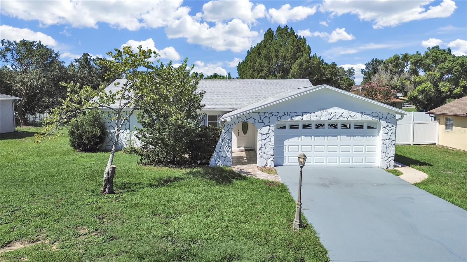 Spacious and freshly renovated single-story home featuring three bedrooms, two bathrooms, and a two-car garage, plus a detached one-car garage with conversion potential. Located in Spring Hill, FL, this property also boasts a beautiful screened-in pool perfect for entertaining.
The seller has replaced the roof, updated the kitchen with new cabinets, countertops, appliances, and lighting, and fully renovated the bathrooms with new vanities and stylish tiled shower and tub enclosures. A covered patio sits under the main roof, protected from the elements by vinyl screen windows, offering a cozy spot to relax year-round.
The detached garage features three windows, a side door facing the pool, a functional roll-up door currently covered with a reversible wall, and a closet. It can be used as a project room, workshop, band space, or extra storage, and it also has strong potential to convert into a mother-in-law suite.
The backyard offers a fruiting loquat tree, bamboo, and a mature shade tree that creates a cool retreat near the exterior storage shed, making it an ideal spot for a grill.
Conveniently located just 15 minutes from the Veteran’s Expressway for an easy commute and approximately 43 miles from Tampa International Airport. Spring Hill, in Hernando County, is part of Florida’s renowned Nature Coast, close to Hernando Beach, Weeki Wachee Springs State Park, the Chassahowitzka River, cave systems, hiking trails, parks, and more.
Contact your favorite real estate agent and schedule a showing today.