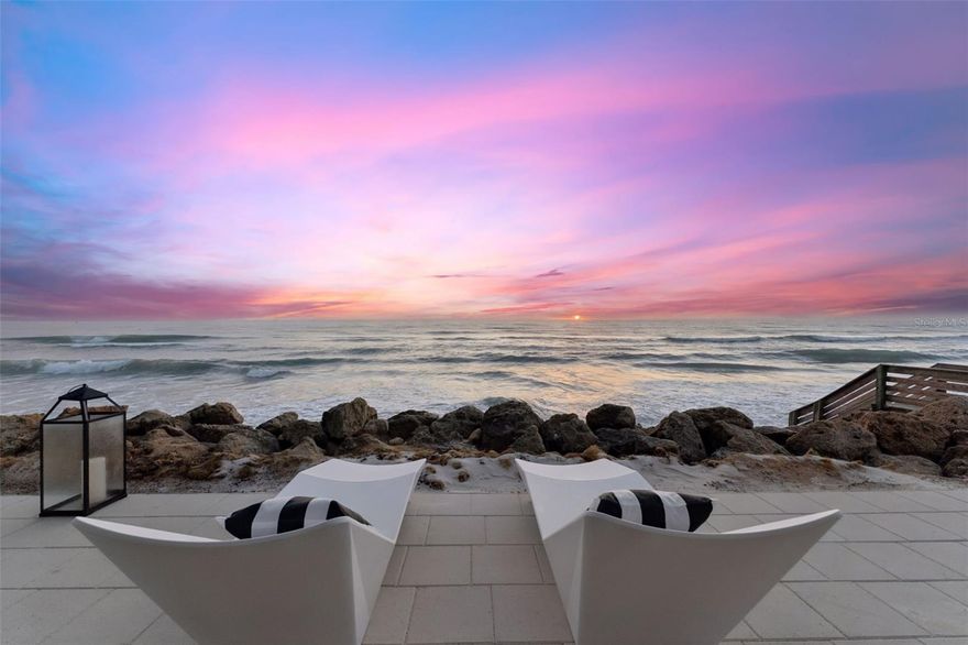 Hitting the market for the first time, Atlantic Sunrise represents a true market debut — privately held through construction and now available for the first time to qualified buyers.Positioned on one of New Smyrna Beach's most coveted stretches of coastline, this extraordinary new construction residence sets an uncompromising new standard for oceanfront luxury. Engineered on 36-foot concrete pilings and built to withstand the full force of Florida's coastal climate, this is a home designed not just for beauty, but for generations.
One detail stops every visitor cold: floor-to-ceiling windows spanning the entire length of the home on every level. The Atlantic Ocean is not a view you look toward, it is a presence that fills every room, every corridor, every waking moment. A private elevator serves all three levels, ensuring seamless access throughout the home.
The heart of the home lives at the top. The third-floor great room is a seamless union of chef's kitchen, dining, and living space where panoramic Atlantic views pour through soaring windows from every angle. The kitchen is anchored by a massive quartz island and a professional-grade ILVE Italian 8-burner range; hand-assembled in Campodarsego, Italy to the exacting standards of Michelin-starred kitchens worldwide. Custom cabinetry conceals an integrated refrigerator, freezer, and dedicated wine refrigerator. Step through to the expansive third-floor balcony, and the full sweep of the beach unfolds before you. Back inside, a book-matched Dekton stone wall anchors the living room, dramatically framing both a large-format television and fireplace within its sweeping form. Bespoke accent lighting throughout transforms every interior into something cinematic after dark.
The second level houses the bedroom suites, including a primary suite opening directly onto its own private balcony overlooking the beach; wake to the surf, step outside to the salt air, and watch the morning light move across the water without leaving your room.
The first floor offers a thoughtfully designed two-bedroom guest wing with its own full kitchen and living area; ideal for extended family, visiting guests, or a live-in caretaker, with complete separation from the main residence and its own ground-level patio opening directly to the beach.
Just minutes away, Canaveral National Seashore preserves over 57,000 acres of pristine Florida wilderness and one of the longest undeveloped stretches of Atlantic coastline on the East Coast. When town calls, legendary Flagler Avenue delivers independent boutiques, acclaimed farm-to-table dining, art galleries, and the kind of authentic local character that larger resort towns lost long ago.
This is not simply a home, it is a complete way of living, where the Atlantic fills every window on every floor and spills onto three levels of outdoor living. Opportunities at this level of quality, craftsmanship, and location are exceedingly rare.