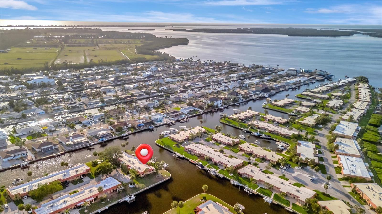 One or more photo(s) has been virtually staged. PRIVATE BOAT DOCK AND LIFT!!!! Just minutes out to the open waters of Palma Bay with NO FIXED BRIDGES!!! MONTHLY DUES ARE ONLY $675 and INCLUDE FLOOD INSURANCE!! Palma Sola Harbour is a gated, waterfront community close to the pristine beach of Anna Maria Island. This light-filled corner condominium is situated at the end of the cul-de-sac and features 2 spacious bedrooms, a large kitchen with an eat-in area, and views of the water from almost every room. Relax on your paver brick patio overlooking the canal... the perfect spot for morning coffee and spectacular sunsets There's ample outside storage to keep your beach gear and tools. Enjoy the community's resort-style amenities that include two heated swimming pools, tennis/pickleball courts, a billiards room, clubhouse with planned social activities, two dry saunas, an exercise room with state-of-the-art equipment, a workshop with tons of tools, and a putting green to practice your shot. Palma Sola Harbour Condos is close to stunning beaches, shopping, dining, and the charming Cortez Fishing Village. This is the perfect opportunity to create your personalized waterfront retreat.