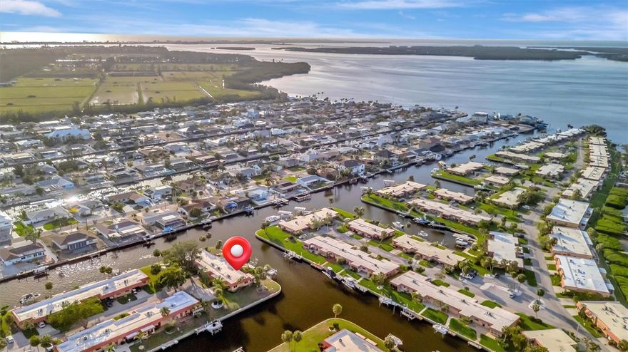 One or more photo(s) has been virtually staged. PRIVATE BOAT DOCK AND LIFT!!!! Just minutes out to the open waters of Palma Bay with NO FIXED BRIDGES!!! MONTHLY DUES ARE ONLY $675 and INCLUDE FLOOD INSURANCE!! Palma Sola Harbour is a gated, waterfront community close to the pristine beach of Anna Maria Island. This light-filled corner condominium is situated at the end of the cul-de-sac and features 2 spacious bedrooms, a large kitchen with an eat-in area, and views of the water from almost every room. Relax on your paver brick patio overlooking the canal... the perfect spot for morning coffee and spectacular sunsets There's ample outside storage to keep your beach gear and tools. Enjoy the community's resort-style amenities that include two heated swimming pools, tennis/pickleball courts, a billiards room, clubhouse with planned social activities, two dry saunas, an exercise room with state-of-the-art equipment, a workshop with tons of tools, and a putting green to practice your shot. Palma Sola Harbour Condos is close to stunning beaches, shopping, dining, and the charming Cortez Fishing Village. This is the perfect opportunity to create your personalized waterfront retreat.