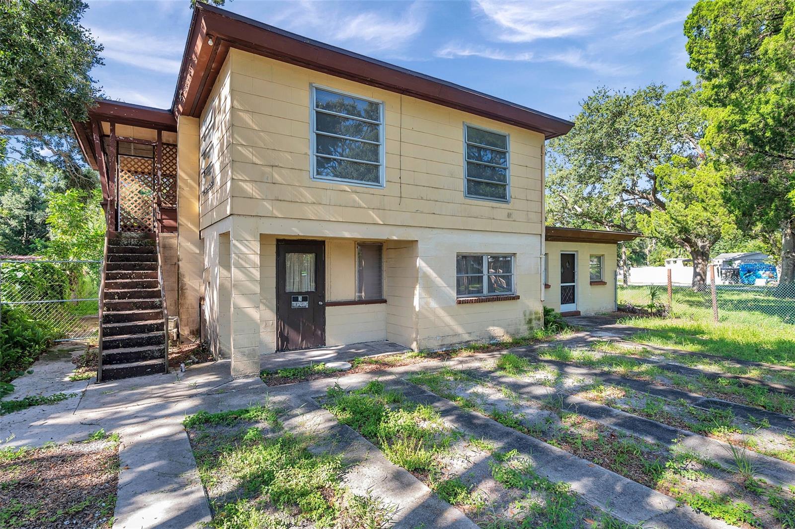 Versatile Investment Opportunity in Unincorporated St. Pete! Tucked away on a spacious 0.27-acre lot, this rare concrete block 5-unit property offers both income potential and development flexibility—all in an X flood zone with no city restrictions. The main home features 4 bedrooms and 2 bathrooms and could easily be separated for owner-occupancy while renting out the other units. Also included: a 2-bedroom, 1-bath unit and three additional 1-bedroom, 1-bath units—ideal for long-term tenants or short-term rental possibilities. With ample room for expansion, redevelopment, or even splitting the lot into two buildable parcels, this property is a strategic play for investors, developers, or those dreaming of house-hacking in sunny Pinellas County. Don't miss this chance to tour a truly unique setup—schedule your private showing today!
