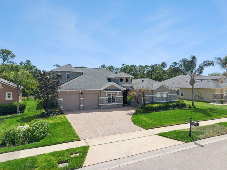 BEAUTIFUL BREEZES AND EXCEPTIONAL VIEWS IN THIS CHARMING HOME LOVINGLY MAINTAINED IN THE FAVORABLE SANCTUARY COMMUNITY! A brick paver driveway and walkways with pretty landscaping and butterfly gardens welcome you to your new chapter of serenity. There’s plenty of space to enjoy everyday living & entertaining in this open & generously sized 5 bedroom, 4 bath and a 3 car garage offering 3,034 sq. ft. of elegant finishes. A spacious and newly remodeled kitchen delivers function & good looks made easy for the entertainer. The Quartz Calacatta Trevis countertops shine and compliment the sparkling backsplash. A breakfast bar, upgraded appliances, 42” cabinetry with soft close drawers and pull out shelving, a new touchless faucet, plenty of pantry space and a nicely sized eat in nook and you’re ready to enjoy your gourmet meal. Looking for a little more formal? Enjoy dinner in your formal dining room conveniently putting the butlers pantry to work. The family room opens to the kitchen and is light and bright due to the windows overlooking the sparkling pond and allowing natural light in creating a cozy atmosphere. The outdoor porch is screened in with a large sitting area and a four person spa perfect for relaxing and listening to the birds - all yours to enjoy privately or with a crowd. A formal living room with a custom stacked stone electric fireplace and cabinets makes it easy to relax. Thoughtfully set far from the busy family area, you'll find a spacious master suite with beautiful views of the hummingbird garden and pond, a tray ceiling with two walk in organized closets and an impressive bathroom complete with two raised sinks, an additional sitting area with new granite countertops & best of all, a new and oversized heated, Jacuzzi tub for luxuriating soaks. A block glass window lead you to a newly remodeled walk in shower. In addition this home has four additional bedrooms including a huge secondary suite perfect for a teenager, guests or the in-laws and ensures ample personal space for everyone to work, play & rest. All of the bathrooms have new granite countertops and newly tiled walk in showers. A simply stunning home built with the most exquisite luxuries. Additional extras to include; crown molding and 5 1/3 baseboards throughout, two newer Trane air conditioners (2021), a newer 80 gallon Hybrid premium water heater (2022), 24 owned solar panels making the home completely solar powered (2012), concrete Polyaspartic Coating for garage flooring (2024), an electric car charger, newer exterior paint (2017), an inside laundry room with more than enough space for folding, plenty of storage, ceiling fans throughout, knockdown ceilings, a Ring doorbell,  impressive volume ceilings with decorative plant shelves and hardwood flooring (2019) and ceramic tile in all traffic areas. Conveniently located in the Sanctuary in a fabulous community with an oversized swimming pool, splash pad, fitness center, basketball courts and pickleball. Imagine ending your day watching the sun set over the glistening water and seeing beautiful wildlife. See this beautiful, move-in ready, model home & enjoy Florida style living at its best!