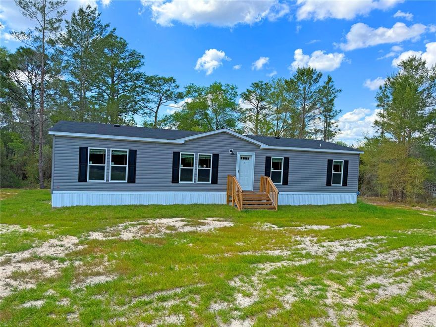 One or more photo(s) has been virtually staged. Seller is offering up to $10,000 toward the buyer's closing costs with an acceptable offer. Welcome to this brand-new 2025 double-wide home, perfectly situated on just over 2 acres along peaceful Whirlwind Lake. Offering privacy, space, and a true country setting, this property features a gravel driveway off a paved road, creating both convenience and a clean, welcoming approach. Zoned AG, you'll have the freedom to bring animals and enjoy the flexibility of rural living at its finest. Inside, this thoughtfully designed home offers 4 bedrooms, 2 bathrooms, and 1,456 square feet of bright, modern living space. Enjoy water views right from your kitchen and dining area, creating the perfect backdrop for everyday living. Everything is brand new--including the well, septic system, and electric pole--providing peace of mind for years to come. Step outside to fresh sod surrounding the home, and a spacious concrete slab out back overlooking the lake-ideal for entertaining, relaxing, or future additions such as a garage, workshop, or storage building. Located in the private community of Melrose Landing, there is no HOA requirement unless you choose to join, which grants access to the private runway and clubhouse--a unique feature for aviation enthusiasts.
While you'll feel tucked away in your own private retreat, you're just minutes from the charm and convenience of nearby communities like Melrose, Hawthorne, Interlachen and Keystone Height. All offer great festivals and a small-town feel surrounded by lakes and natural beauty. Spend your days enjoying Santa Fe Lake Park for boating, fishing, and relaxing by the water, or explore local creativity at Gallery 26. Dining options are plentiful, from classic Southern barbecue at Dianne's Old Time BarBq, to casual bites at Burger Barn and fresh, quick options at The Wrap Shack. Enjoy local favorites like Blue Water Bay Restaurant, along with cozy cafés and ice cream stops such as Frozen Pelican. Convenient grocery options and small-town shops make daily living easy and enjoyable. Hawthorne is rich in history and known for its agricultural roots and rural charm. Outdoor enthusiasts will love exploring Marjorie Kinnan Rawlings Historic State Park, biking or walking along the scenic Gainesville-Hawthorne State Trail, or enjoying nature at Little Orange Creek Nature Park. Fresh, locally grown produce can be found at Brown's Farm, adding to the area's authentic country lifestyle. With lakefront access, acreage, agricultural zoning, and a completely new home, this property delivers the perfect combination of space, flexibility, and the peaceful Florida lifestyle.

ALL PICTURES SHOWING FURNITURE is VIRTUALLY STAGED to show what the space could look like.