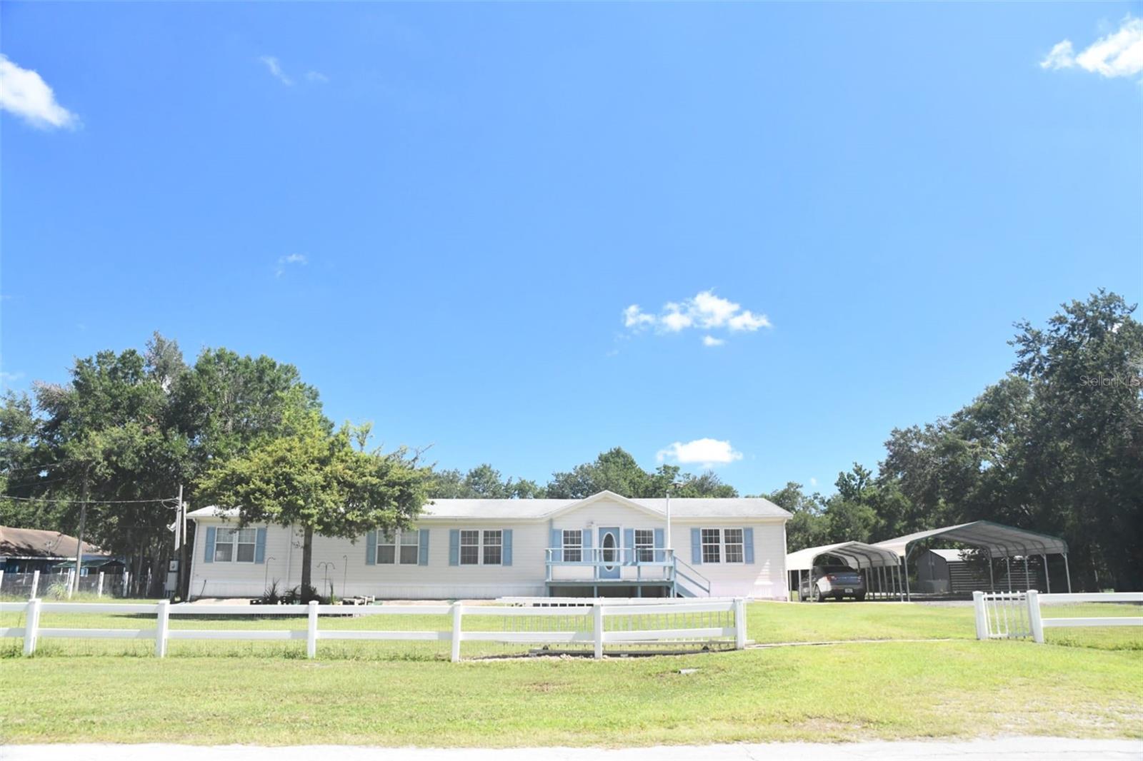 Over 1 acre nestled in the heart of Wesley Chapel, this charming 3-bedroom, 2-bathroom home on Eastport Dr. offers an ideal blend of comfort, style, and convenience. 2,280 Sq Ft of living space, the open floor plan creates an inviting atmosphere, making this home perfect for both everyday living and entertaining. Property features 2 wood burning fire places one in the family room and another in the living room. Whether you’re hosting family gatherings or enjoying a quiet evening, the spacious living areas provide ample flexibility. Step inside to discover beautiful hardwood floors that flow seamlessly throughout the main living spaces. The kitchen is a true showstopper with stainless steel appliances, granite countertops, and ample cabinet space. The private backyard is your own personal paradise, offering plenty of room for outdoor activities. There is ample space on the property for parking a truck, boat, rv and much more. Carports cover 3 vehicles. Roof is less than 5 years old. This home is just minutes away from top-rated schools, shopping centers, dining, and entertainment options. With easy access to I-75, commuting to Tampa and surrounding areas is a breeze. Don’t miss the chance to make this gem your forever home! No Restrictions, HOA or CDD!