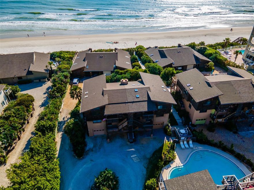 Townhome with ocean views located in the desirable Sea Dunes subdivision just steps to the beach. The 2nd and 3rd stories feature two separate living areas, including full kitchens, with separate entrances. The 3rd floor has 2 bedrooms, 2 bathrooms, and gorgeous ocean views from the expansive front deck. The 2nd floor has 2 bedrooms, 1 bathroom, and a large patio that connects to the boardwalk that leads directly to the beach. The first floor has two 1-car garages. There is an elevator inside the home for access to all 3 floors. Several recent updates including a new water heater in 2020, new AC units in 2018, new dishwasher, washer, and dryer in 2017. Both decks were redone in 2019. New gutters in 2018. Garage doors were sanded and painted in 2016. Perfect opportunity to live in one unit, and use the other for family or rental income. Close to shopping and dining, and only a short drive to Flagler Ave. ;Water: City