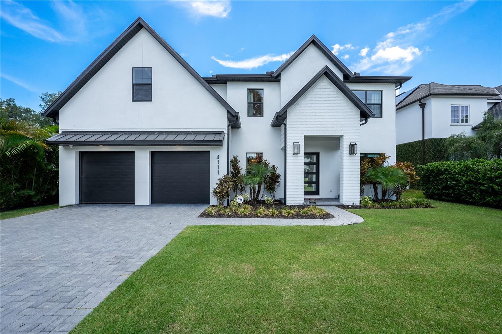 Welcome to an extraordinary blend of luxury, location, and lifestyle in one of South Tampa’s most coveted neighborhoods. This stunning new construction masterpiece by Momentum Homes offers 5 bedrooms, 4.5 baths, and over 4,500 square feet of expertly designed living space—crafted for both everyday comfort and elegant entertaining. This home stood high and dry with no issues throughout hurricane season 24.
Built solid with block construction on both levels and impact-rated Low E windows, this home marries timeless architecture with modern durability. Step inside to find wide-plank white oak flooring, custom wood cabinetry, and a chef’s dream kitchen featuring a 48” Thermador gas cooktop, quartz island, butler’s pantry, and functional mudroom. The open-concept living area is anchored by a showstopping gas fireplace and flows seamlessly into a dedicated office and media room.
Retreat to the first-floor guest suite with en-suite bath and direct pool access—ideal for visitors or multigenerational living. Upstairs, the luxurious primary suite impresses with an oversized walk-in closet and spa-inspired bath complete with a freestanding soaking tub and frameless glass shower.
Out back, enjoy a true resort-style escape: a sparkling pool and spa, covered patio with built-in grill, sink, refrigerator, and lush professional landscaping framed by a classic brick-paver driveway. Zoned for top-rated Grady, Coleman, and Plant schools.
This is more than a home—it’s a statement. Don’t miss your chance to own a rare new construction offering in Swann Estates.