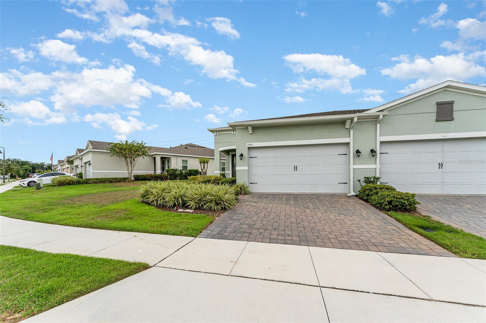 Welcome to this beautifully maintained 2-bedroom, 2-bath villa with a 2-car garage in the highly desirable Four Seasons at Orlando! Barely lived in, this home feels truly move-in ready. The open, light-filled floor plan features stylish upgrades, including luxury vinyl flooring, tray ceilings, and thoughtfully designed finishes throughout. The gourmet kitchen offers quartz countertops, modern appliances, abundant cabinetry, and a spacious island perfect for everyday living or entertaining. The primary suite serves as a private retreat with dual sinks, a walk-in shower, and a generous walk-in closet. A versatile second bedroom works well for guests, hobbies, or a home office. Step outside to the open lanai—an inviting space for morning coffee, evening relaxation, or entertaining friends. As a resident of Four Seasons, you’ll have access to a vibrant 55+ community designed around active living. Spend your days at the beautifully appointed clubhouse, take a dip in the resort-style pools, stay active with tennis, pickleball, bocce, or the fitness center, and enjoy the walking paths that wind through the neighborhood. The community also connects to the scenic Mystic Dunes Golf Course. With lawn care and exterior maintenance included in the HOA, you can focus on enjoying life instead of yard work. All of this is just minutes from Celebration, world-class attractions, shopping, dining, and top-rated healthcare, making this villa an ideal blend of convenience and lifestyle.