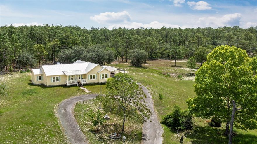 *Inside photos will be added soon*Tucked away in the heart of Levy County, this 13.770-acre gated and fully fenced country property offers the perfect blend of seclusion, comfort, and functionality. Built in 2006 and thoughtfully updated, the home features 2,366 square feet of living space with a split floor plan that includes three spacious bedrooms and three bathrooms. Step inside to soaring 10-foot ceilings, rich bamboo floors, and an abundance of natural light that fills the open-concept living area. The inviting gas fireplace adds warmth and charm, while the dedicated dining room creates a welcoming space for family meals and entertaining guests. The kitchen is beautifully designed and equipped with a new gas cooktop, built-in electric oven, refrigerator, and dishwasher—perfect for both everyday living and special gatherings. A separate laundry room adds convenience, while the large Florida room at the back of the home offers additional space to relax, unwind, or enjoy views of the peaceful surroundings year-round. The primary suite is a true retreat, featuring a spacious bedroom, a private office or sitting area, and a luxurious en suite bath complete with a custom soaking tub, walk-in shower, dual sinks, an extended makeup vanity, and a generous walk-in closet. Recent upgrades include a three-year-old metal roof, a new air conditioning system, and updated windows throughout, providing modern efficiency and peace of mind. Outdoors, the property is fully enclosed with chain-link fencing and features a newly installed board fence at the gated entrance, creating a grand and secure entry. A 250-gallon underground propane tank supports the home’s gas appliances, and the 56’ by 54’ fully enclosed farm shop offers ample space for equipment storage, projects, or hobbies. Additionally, a covered carport with an attached shed provides extra shelter for vehicles and tools. The property is also equipped with two wells, including a 150-foot deep well that taps into the aquifer, offering a reliable and abundant water source for both household and agricultural use. Whether you’re looking for a quiet homestead, a hobby farm, or a private retreat surrounded by nature, this one-of-a-kind property offers a rare opportunity to enjoy the very best of country living in Levy County.