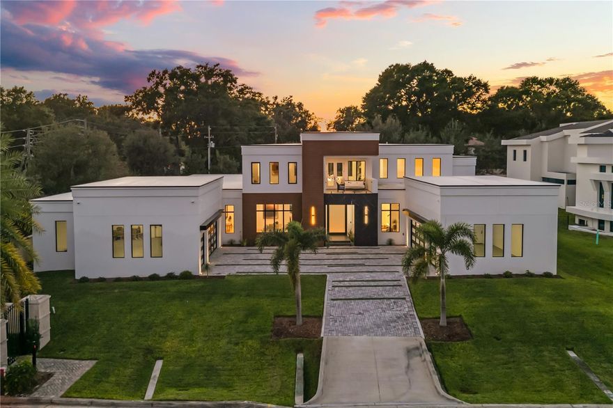 Welcome to a rare modern estate inside an intimate gated enclave, offering 6,816 square feet of fully furnished luxury with six bedrooms, six full baths and two half baths. Every detail of this custom-built masterpiece was designed for those who value privacy, prestige and perfection. Go inside to discover European white oak flooring, soaring ceilings and designer-curated finishes that define understated elegance. The chef’s kitchen features Wolf appliances, an oversized island, and custom cabinetry that flows seamlessly into open-concept living and dining spaces, ideal for entertaining or effortless daily living. The first-floor primary suite is a sanctuary of its own, with a two-story boutique-style dressing room and a spa-inspired bath showcasing dual vanities, a freestanding soaking tub and a double rainfall shower beneath a skylight. Upstairs, each bedroom offers its private en suite, including a flexible Jack and Jill layout. Additional highlights include a private theater, executive office, and a detached casita ideal for guests or multigenerational living. Outdoors, experience your resort retreat, a negative-edge pool with cascading waterfalls, spa jacuzzi, covered lanai, and fully equipped outdoor kitchen built for year-round entertaining. In a small, exclusive gated community, this property delivers a balance of modern sophistication and timeless comfort. Homes of this caliber rarely become available. Schedule your private showing today and experience why this estate stands in a class of its own.