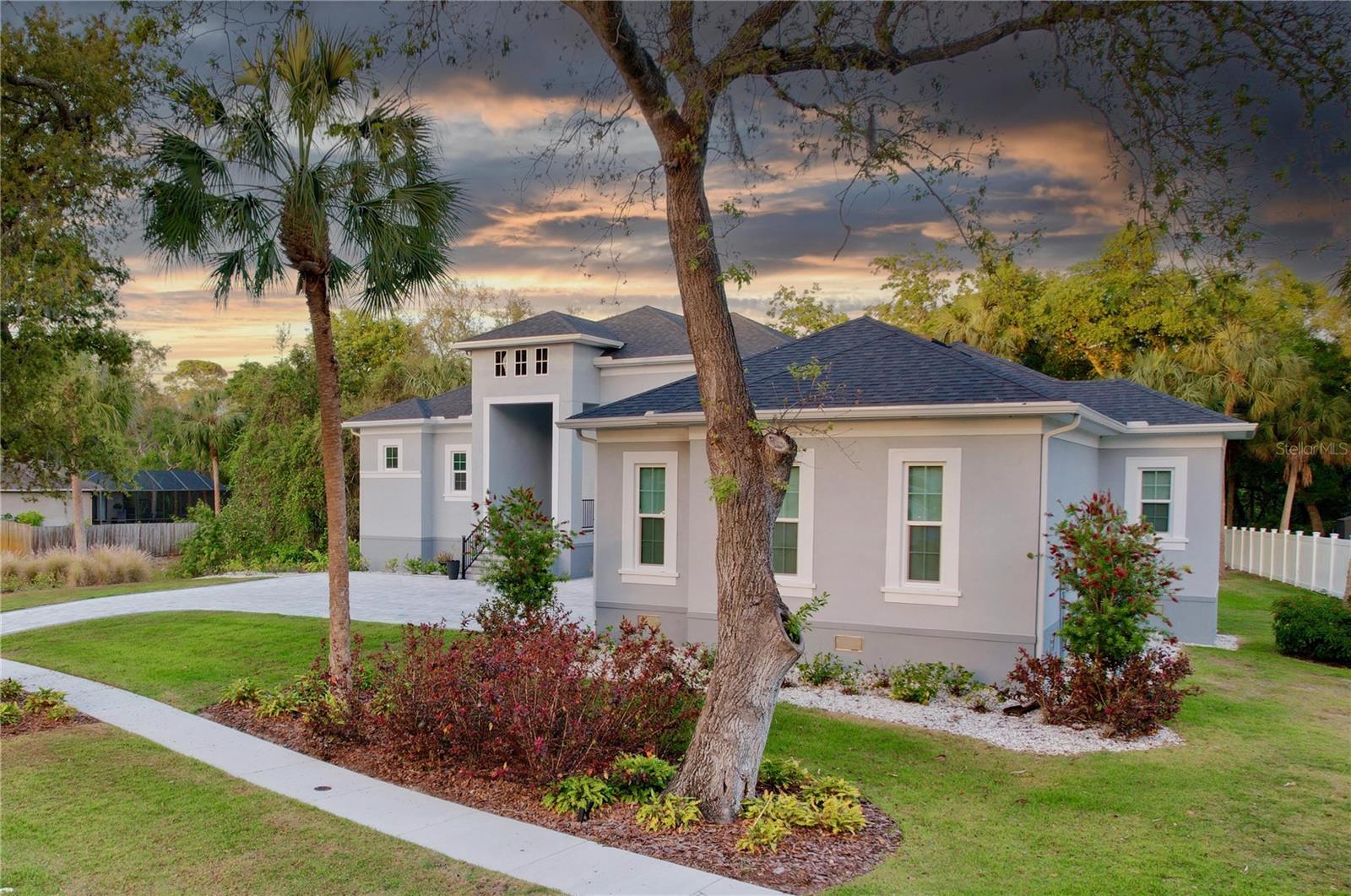 Boasting a brand-new and bold lower-price, you won’t want to miss out on this rare and amazing opportunity to own your dream home! This 2022 custom-built luxury home has everything on your list:Gated community? Check. Deeded boat slip on the Anclote River? Check. Concrete construction, built at 15 feet with the latest hurricane standards and custom impact windows? Check. Smart-home features both inside and out? Check! Your deeded 10K-pound boat lift (refurbished in ‘21) includes a new remote, aluminum bunk rails, catwalk, and electric/water connections, all on the river just minutes away from Anclote Key and the open Gulf. Inside the double designer front doors, you will find a modern open floor plan with LVP flooring throughout, soaring ceilings, and lots of natural light. The kitchen is at the center of everything and features quartz countertops, a tile backsplash, and a large island with a breakfast bar, in and out-facing cabinets, and pendant lights. A spacious walk-in pantry with built in floor-to-ceiling shelves completes this gourmet space. Just steps away, the lanai with retractable power screens offers perfect Florida views of nature, which you can enjoy while relaxing in your Marquis 5-person spa. Open the screens to entertain guests or catch some rays on the extended composite deck, which leads to the lush backyard with your own private river lagoon, home to a vibrant bird sanctuary. The primary suite features tray ceilings and separate access to the lanai and spa, while the ensuite boasts two large walk-in closets with custom closet systems, a W/C, a granite-topped vanity with dual sinks, and a massive custom-tiled shower. On the other side of the home, a junior suite offers an ensuite with walk-in shower, large walk-in closet with a custom closet system, and all the same high-end finishes found throughout the rest of the home. Two additional guest bedrooms share the third full bathroom with tub/shower. The den/5th bedroom just off the foyer features 8-foot French doors and makes the perfect home office. The inside large laundry room includes a deep sink, front-facing window, and lots of cabinetry. The LG washer and dryer will convey. The nearly 1,000 square foot side-entry 3-car garage was built with a large separate storage room giving you plenty of additional storage!Other features of this home include: Generac 22 kW whole-home generator, smart home technology with Lutron lighting & fan controls, a wired alarm system with 4 exterior cameras, and various wi-fi controlled gadgets like window shades, deadbolt locks, garage door openers, lawn irrigation system & thermostat. Meyer’s Cove is a quiet, gated cul-de-sac community that consists of only 16 oversized homesites, all with custom-built homes. The HOA fees cover the common grounds landscaping, gate and dock maintenance, and community areas. Prefer to stay on dry land? You’ll be about 10 minutes from all the shopping & dining of the world-famous sponge docks of Tarpon Springs, and less than 40 minutes from those beautiful Clearwater beaches. Tampa & St. Pete are both just under one hour away!
