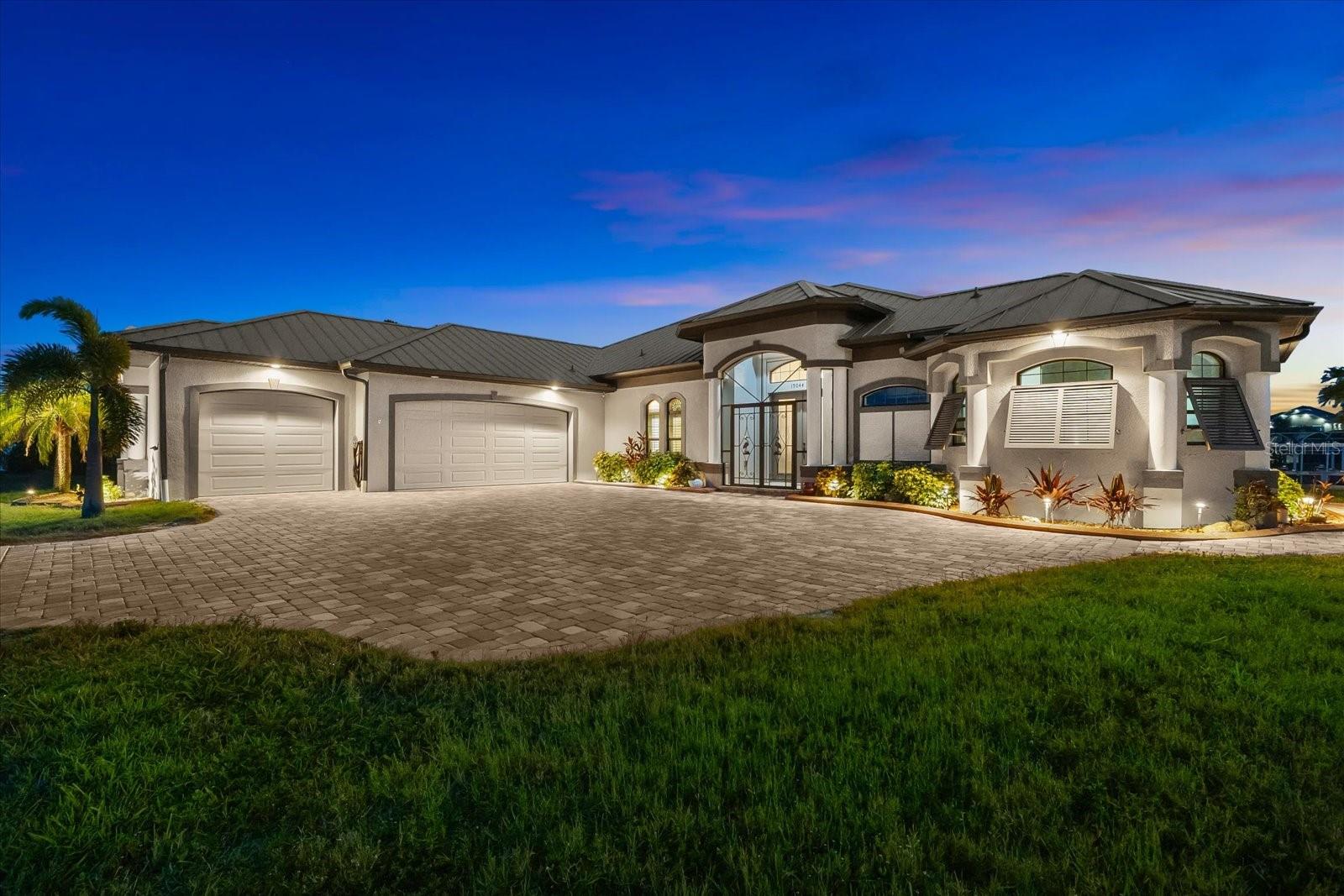 Experience the best of Florida living in this custom-built estate home, featuring 4 bedrooms, 3.5 baths, and a den, beautifully positioned on 1.25 acres along the Zephyr Waterway with 125 feet of sea-walled waterfront and ideal southern exposure. Built in 2018, this 2,681 sq ft estate offers the perfect blend of luxury, privacy, and easy access to both boating and nearby golf courses in the highly desirable South Gulf Cove community. Enjoy stunning views and vibrant boat traffic from your backyard on one of the area’s most sought-after wide canals. Inside, the home boasts a thoughtfully designed open floor plan with a double tray volume ceiling, gorgeous plank flooring throughout, and expansive 0° sliders that flood the main living areas with natural light, offering seamless indoor-outdoor living. A den with French doors provides an ideal space for a home office or cozy retreat. The heart of the home is the gourmet kitchen, designed to impress with upgraded granite countertops, a dramatic 10-foot island, staggered cabinetry, and decorative backsplash tile that extends to the ceiling. A spacious walk-in pantry and a state-of-the-art 2023 induction stove complete this high-end culinary space, perfect for both everyday living and entertaining. The expansive primary suite serves as a serene retreat, featuring a decorative ceiling, ample space for a seating area, and large windows that allow natural light to fill the room. The spa-like ensuite bath offers a luxurious walk-through shower with dual showerheads, double vanities, and a deep soaking tub—creating the perfect blend of comfort, elegance, and functionality. For added privacy, the guest bedrooms are located on the opposite side of the home, each with convenient access to their own bathrooms, making them ideal for family or visitors. Outdoor living is a true highlight of this property. Relax in the heated pool, surrounded by mature landscaping and protected by roll-down shutters on the lanai. A separate bar area with a refrigerator, sink, and icemaker makes entertaining a breeze. The full irrigation system keeps the expansive yard green year-round. Waterfront amenities include a 10,000 lb covered boat lift, water and electric at the dock, and a paver pad running the full 125 feet of sea-walled waterfront, providing a clean, polished look and convenient access along the shoreline. Additional upgrades include a new roof (2023), impact windows and doors, Bahama shutters, electric remote-controlled room-darkening shades, and a whole-house generator plug for added peace of mind. The three-car garage boasts a durable epoxy floor, and two outdoor sheds provide convenient extra storage. Don’t miss this rare opportunity—schedule your private showing today!