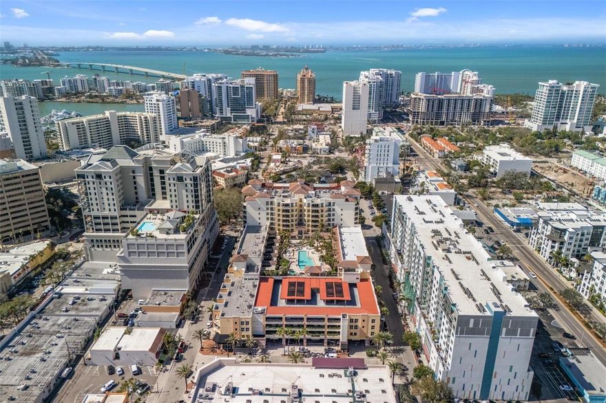 Nestled in the heart of downtown Sarasota, One Hundred Central is a premier address just steps from the Opera, Theaters, upscale boutiques, gourmet restaurants, and the sparkling Bayfront. The walkability is simply unmatched. This modern two-bedroom, two-bath residence offers luxury and convenience, featuring two deeded garage spaces, an air-conditioned storage unit, and bike storage. Inside, a sophisticated, urban space featuring crown molding and sleek tile floors create a refined ambiance. The spacious living room boasts a custom-built entertainment center, while expansive sliding glass doors open to a covered terrace—perfect for unwinding. Soak in the vibrant skyline and embrace the energy of city life. The kitchen showcases granite countertops, rich wood cabinetry, and newer appliances. The primary suite extends to the terrace and includes a generous walk-in closet and en-suite bath. A versatile second bedroom features custom built-ins, including a Murphy bed, desk, book shelves and storage, transforming the space, with ease,  into a sleek office. Across the hall, a second full bath is adjacent to the laundry closet with a newly replaced full-size washer and dryer. Additional upgrades include a new AC system and a high-quality water heater. Resort-style amenities elevate the lifestyle—swim in the heated lap pool, unwind in the spa, or entertain at the outdoor grills and lounge areas. A state-of-the-art gym, art studio, theater room, and guest suite cater to every need. The community room, with a fireplace, kitchen, and bar, is perfect for private gatherings. With Whole Foods and Starbucks just an elevator ride away, every luxury is at your fingertips. Pet-friendly and impeccably maintained, One Hundred Central offers a world-class, maintenance-free lifestyle in the heart of Sarasota. Your dream residence awaits.