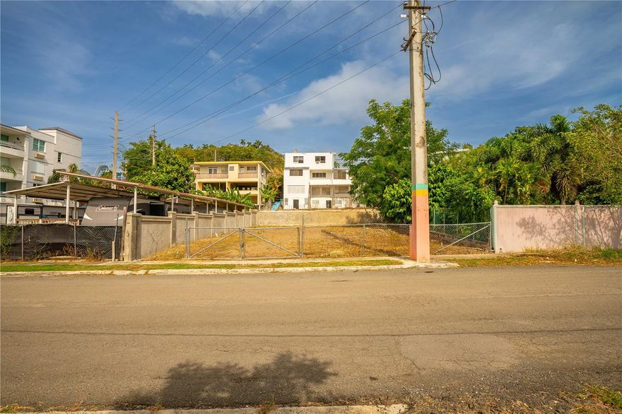 Location, location, location.  This is the best of the best in Rincon and it tops all.   Walk to the downtown plaza, farmers market, Art Walk, restaurants, shops and bars.  Public Beach with calm water, perfect for swimming and paddle boarding is within walking distanc.  A bit further to great surfing and snorkeling at Tres Palmas!  This flat, 465 sq meter lot has been improved by a six foot concrete wall on 3 sides.  Utilities are at the road and seller is offering PERMITTED plans for a 2 story residence.