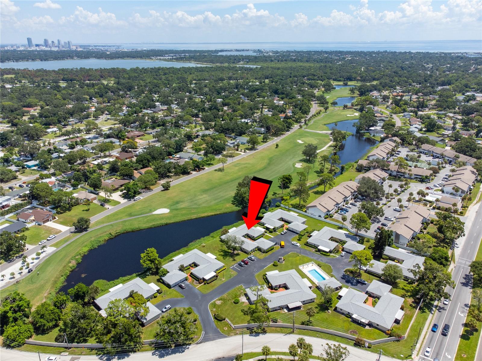 Welcome home to your Country Club Villa! Move-in ready. furnished or unfurnished. The location is ideal overlooking the 13th Fairway and a serene pond. The property is situated steps away from the highly sought after St. Petersburg Country Club, which offers several amenities such as golf, tennis, swimming, fitness, event space, a restaurant, and more! For more information call the ST PETERSBURG COUNTRY CLUB. Once arriving at the quaint Country Club Villas community, you will notice the meticulously manicured grounds and how charming the community is. Upon entry into your end unit, please take note of the abundance of natural light and how open the floorplan is laid out which is perfect for those that love to entertain or just like the open feel. The main living area is shared with the dining area and overlooks the incredibly large, enclosed lanai. There are 2 bedrooms and 2 baths along with an indoor laundry that comes with a Full size Washer and Dryer. The bedrooms are quite sizable. The master bath ensuite includes a separate vanity space from the walk in shower. The guest bath has a tub/shower combo. The Lanai is approximately 188 sq ft and overlooks the beautiful 13th fairway and small pond. This "bonus" space could easily be utilized as a home office, art studio, fitness room, and/or an additional entertaining area. The unit is conveniently located near the beautiful community pool and your personal garage/additional storage area. HOA fee includes cable TV, water, sewer, trash, exterior & grounds maintenance, pool maintenance, pest control and more! Don't miss your opportunity to own this great Villa home in a highly desirable area- only 6 minutes to Eckerd College and 10 minutes to Downtown St Pete or St Pete Beach! 5 minutes or less to 2 major grocery stores and shopping. Downtown is approx 8 min away.