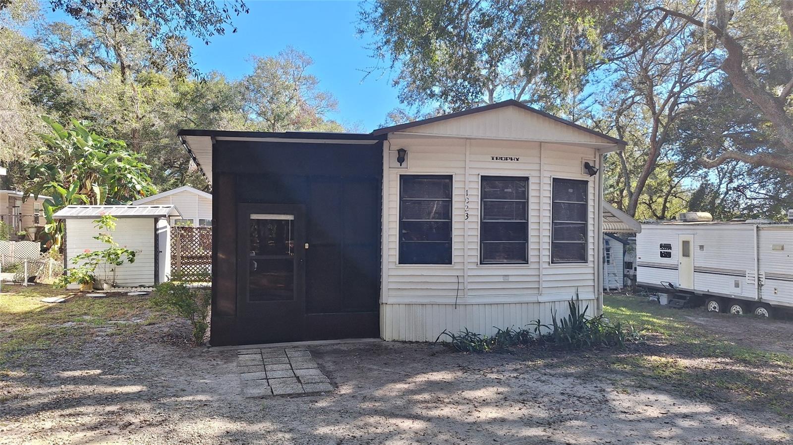 YOU OWN THE LAND AND THIS BEAUTIFUL MOBILE HOME IN PERFECT CONDITION, ON THIS NICE SIZED LOT THAT HAS A WASHER AND DRYER CONNECTION. GATED COMMUNITY AND LOTS TO DO. Lowest cost of living you can find in the Orlando area, HUGE POOL! Reasonable community HOA includes water, sewer and trash pickup, mini golf course, basketball court, game room, a community recreation room and bingo and much more, and just 30 minutes from Disney and all other attractions.