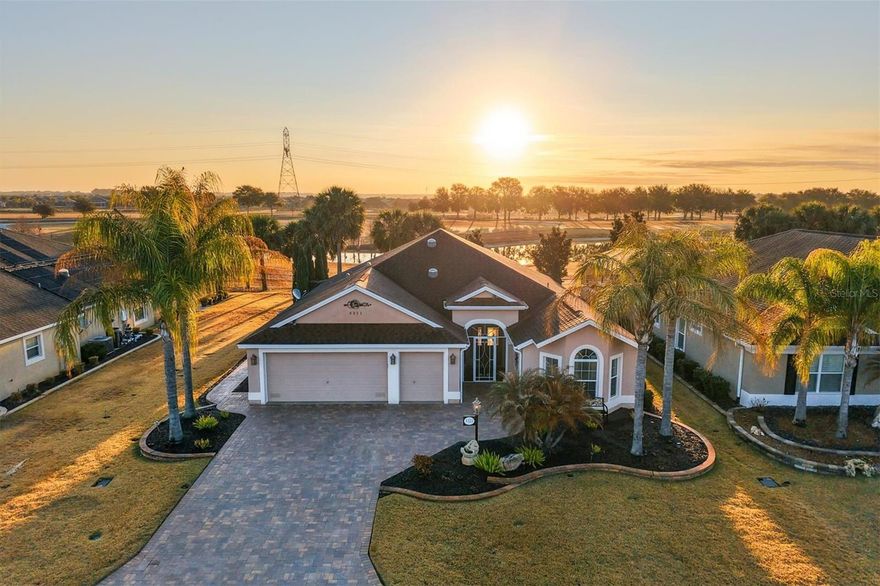 Golf and Water View Begonia Designer • Golf Cart Garage • Desirable Championship Golf Course • East Facing Outdoor Retreat • 2025 Luxury Vinyl Plank Flooring. You will be in awe and feel right at home when you arrive at this BEAUTIFULLY MAINTAINED 3 Bedroom / 2 Bathroom STRETCHED BEGONIA DESIGNER HOME offering Championship GOLF AND WATER VIEWS with an offset view of the 8th tee on the Seminole Nine at Belle Glade Championship Golf Course in The Villages, Florida. The EAST-FACING REAR exposure captures MAGNIFICENT SUNRISES and serene surroundings, creating an exceptional outdoor living experience. From the moment you arrive, the WIDE PAVER DRIVEWAY, DETAILED LANDSCAPING, and screened front porch establish inviting curb appeal and a comfortable entry. Inside, NEW 9-INCH LUXURY VINYL PLANK installed in late 2025 runs continuously throughout the home, creating a modern and cohesive look. The split bedroom floorplan provides privacy, with a pocket door separating the guest suite from the main living area. The front bedroom features a bump out for added space and a closet, while the middle bedroom includes a vaulted ceiling and closet. The Primary Suite offers a tray ceiling, double closets including one with built ins, and an ensuite with Roman shower, split comfort height vanities, private water closet, and ample storage. The kitchen connects seamlessly to the living and outdoor spaces with a generous serving and breakfast bar overlooking the golf and water views. Abundant cabinetry with pull outs, a breakfast nook, stainless steel appliances including a CONVECTION OVEN, under cabinet lighting, electrical outlets above cabinetry, and two SOLAR TUBES provide both function and natural light. The dining and living areas flow together and showcase the outdoor setting through French doors leading to an extended lanai with remote controlled privacy shades and electric fireplace, extending the interior living space. The backyard is thoughtfully designed with a paver walkway from front to rear, pergolas, stacked stone bordered firepit, multiple fountains, and dedicated gathering areas. Whether entertaining, relaxing by the fire, or enjoying morning sun over the golf course and water, this outdoor space offers a rare level of detail. Additional nearby amenities include LaBelle Recreation Center at approximately 0.6 miles, Belle Glade Country Club and Restaurant at approximately 1 mile, Atlas Canine Park at approximately 0.7 miles, Walmart Neighborhood Market and Gas at approximately 2.2 miles, and Colony Plaza with shopping, groceries, and dining at approximately 2.5 miles. This Begonia Designer combines golf and water views, refined interior updates, and curated outdoor living in one exceptional Belle Glade location. Enjoy The Villages, FL, lifestyle with abundant amenities for you to attend golfing, shopping, dining, and enjoy many entertainment choices, club meetings, medical services, and more, all accessible by a golf cart.