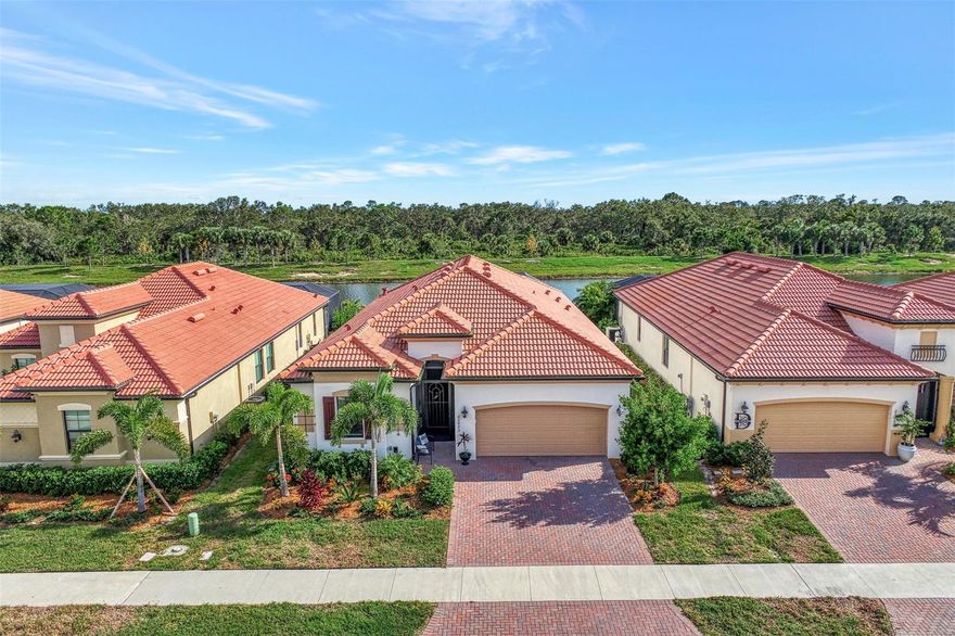 Prepare to be impressed by this beautifully upgraded golf home, located in the highly sought after gated lifestyle community of Sarasota National. This rarely available “Maria” model is one of the most sought-after floor plans, boasting all HURRICANE IMPACT WINDOWS, 4 bedrooms, 3 full bathrooms, and an open concept floor plan that was strategically designed for entertaining and everyday living. The monthly HOA Fee includes 2 GOLF MEMBERSHIPS, with no extra buy-in fees! A designer custom pool was recently installed, and it is guaranteed to blow you away! Enjoy sweeping SOUTH facing private lake views, framed by preserve, all from the comfort of an extended and oversized pool deck that was designed with entertaining in mind. Under the stately travertine stone is a poured concrete deck (never worry about sinking/settling pavers or pesky weeds). The heated saltwater pool and spa, with pebble tec interior and LED lights, was designed as a backyard oasis. Across the back you will enjoy an upgraded clear view screen that perfectly frames the view, making this truly a tranquil paradise. There is an outdoor kitchen featuring built-in grill, decorative stone wall and wood ceiling, and pendant lighting. Storm Smart Hurricane protection was added across the lanai. Inside, you will find upgrades that include custom paint, decorative crown moldings, plank tile flooring that runs throughout the entire home (no carpet anywhere!), 8-foot doors, designer light fixtures and fans, plantation shutters, wood shelving throughout (no wire shelving), tray ceilings, and so much more! The kitchen is a chef’s dream and showcases tons of upgraded cabinet storage, a massive island that is perfect for serving, gourmet built-in appliance package, and a large walk-in pantry. Extra touches such as under cabinet lighting and decorative backsplash make this space truly special. Just off the foyer, there are two light filled bedrooms that share a full bathroom that was just renovated to include custom tile work. One of the bedrooms has double pocket doors, making this the ideal space for an office or den if you need it. Across the foyer is a bedroom with en suite bathroom that includes a walk-in shower that was also renovated with all new custom tile to the ceiling, new fixtures, and new glass doors. In the back of the house, you will find a primary suite that includes a tray ceiling and large slider leading to the lanai. The primary bathroom is appointed with a massive seamless glass walk-in shower, dual sink vanity, and separate water closet for privacy. 2 nice sized closets provide ample storage. Separate laundry room with additional cabinets for storage and convenient utility sink. Live like you are on a 5-star vacation with a 30,000sf clubhouse with resort style pool, hot tub, outdoor tiki bar serving food and drinks, coffee house, fine dining restaurant, golf club restaurant, 7,000sf fitness center with top-of-the-line equipment and classes, day spa, card room, bocce ball, pickle ball, tennis, dog park, playground, event lawn, and 18-hole championship golf course. Sarasota National is a guard gated 2400-acre International Audubon Bird Sanctuary that offers some of the most beautiful lakes and preserves in all of Venice. This home is just minutes from the new Atlanta Brave's spring training camp at the CoolToday Park Stadium, as well as the town center of Wellen Park. Explore 3 local beaches and historic downtown Venice, all less than 15 minutes from your front door!