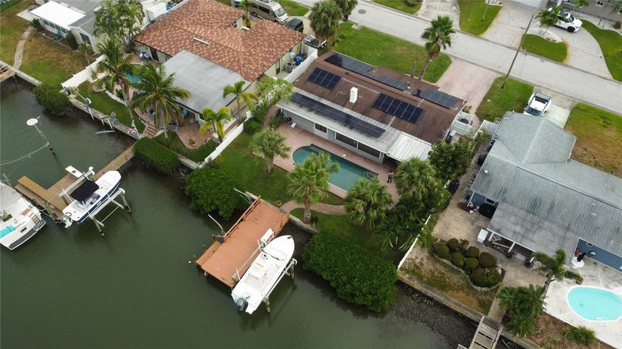 Located minutes from the beach and just 10 minutes from Downtown St. Petersburg, this 3-bedroom, 3-bath canal-front home offers prime potential in one of the area’s most sought-after waterfront neighborhoods. Remediated after Hurricane Helene, it’s ready for renovation or new construction to create your dream coastal retreat. The backyard features brick pavers, a heated saltwater pool and spa, and a sturdy seawall along the canal leading to Boca Ciega Bay. The dock offers two lifts (one electric, one manual) with new motors plus water and electric hookups. The seller is open to selling the 24-ft 2019 Robalo 246 Cayman separately or as part of a package with the home. Additional highlights include new Pella windows, 2022 solar panels, a 2022 HVAC system unaffected by the storm, and a 2009 roof. The waterfront primary suite showcases peaceful canal views, and the Pinellas Trail is just 1.3 miles away—an unbeatable opportunity for a true Florida waterfront lifestyle.