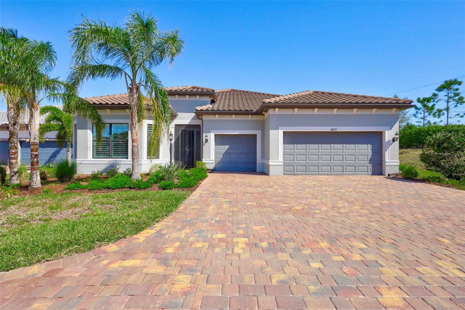 If you’re looking for luxury, space, and resort-style living, you’re in the right place at Lakewood Ranch's premier 55+ community, Del Webb. This stunning residence offers 3 spacious bedrooms, a den/office, and 3.5 bathrooms PLUS a pool bath, offering ample space for both relaxation and entertainment. With an oversized driveway and extended 3 car, air conditioned garage, you’ll have plenty of room for family, guests or even a golf cart! Nestled at the end of a quiet cul-de-sac, this home offers privacy and a peaceful setting.
As you step inside, you're greeted by elegant plank tile flooring that flows seamlessly throughout the whole home. The high ceilings adorned with crown molding enhance the home's airy ambiance, while plantation shutters provide both style and privacy. The gourmet kitchen is a chef's delight, featuring KitchenAid appliances including 2 ovens, quartz countertops, and a large island perfect for casual dining or hosting gatherings. The primary suite is a true retreat, offering a spacious layout with a custom closet designed to meet all your storage needs. A second primary walk-in closet connects to the laundry room for true convenience. Relax in your tub after a long day in your spa-like primary bathroom. The additional bedrooms are generously sized and include en-suite baths and walk-in closets, providing comfort for family or guests.
Unwind outside on your a covered lanai or take a dip in the heated saltwater pool and spa while enjoying the pond view. The remote shades on the lanai and slider offer additional privacy and shade.
Del Webb offers residents a blend of luxurious amenities and vibrant social opportunities designed for an active lifestyle, including a clubhouse, resort-style pool, fitness center, sports courts, dog park, Lakehouse Restaurant and Bar, walking paths and more.
Don't miss the opportunity to own this exquisite home that combines luxury, comfort, and the vibrant community lifestyle of Lakewood Ranch. Schedule your private tour today and experience firsthand what makes this property truly exceptional.