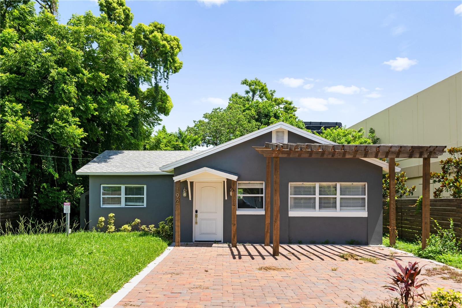 Charming, Fully Renovated Bungalow in the Heart of Winter Park! Welcome to this beautifully upgraded bungalow that makes every square foot count! Nestled perfectly between Winter Park and College Park, this fully renovated gem blends modern upgrades with timeless charm.
From the moment you arrive, the custom-built front pergola and all-new paver driveway invite you in with style.
Step inside to discover a cozy yet efficient layout filled with thoughtful details: barn doors, built-ins, a cabinet pantry, and a linen closet in the guest bath that add character and storage throughout. The brand-new kitchen is compact but packed with quality—featuring granite countertops, stainless steel appliances, and custom cabinetry that maximizes function and charm.
The spacious primary suite offers a walk-in closet and an en-suite bath with a very large walk-in shower. Other unique features include a charming barn door to separate the laundry area from the guest bath, optimizing flow and privacy, an extended and brand new paver driveway, along with a beautiful custom fence and storage sheds that provides added storage. This charming bungalow has been designed to live larger than its footprint. Don’t miss your chance to own this thoughtfully designed home in one of Central Florida’s most desirable locations!