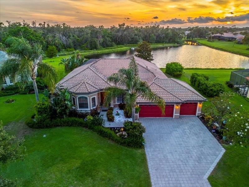 Welcome to your new "Home for the Holidays" with this gorgeous gem located in the coveted Country Meadows community. This popular Barbados model by Medallion Homes is everything you've been looking for. Quality craftsmanship, attention to detail, lush tropical landscaping and nestled on a quiet cul-de-sac with a half acre lot. Outdoor features of the home include an oversized lanai, newly resurfaced, large heated saltwater pool with spa, brand new heater and pump (both in 2025), built-in underwater barstools, perfect for relaxing and entertaining and positioned to bask in the sunlight all day. Outdoor kitchen with grill and new mini fridge included. Relax and unwind while enjoying spectacular Florida sunsets over your long lake and preserve views. Four oversized sliders seamlessly blend indoor and outdoor living. Inside the 4-bedroom, 3-bathroom home is equally impressive, boasting an array of desirable features. The spacious master suite includes private access to the the lanai, double walk-in closets, and a luxurious en-suite bath with a Roman shower, large corner Jacuzzi tub, double sinks and a heated towel rack to enhance a spa-like feel. With 10-foot ceilings throughout and tray ceilings in the foyer and formal living area, this home exudes an open and airy feel. A dedicated home office/den provides space for productivity. The elegant formal dining room leads to a butler's pantry, seamlessly connecting to the gourmet kitchen, complete with stainless steel appliances, double ovens, granite countertops, and solid wood cabinetry. Under the sink, a reverse osmosis system conveys. Finally, the cozy breakfast nook, complete with aquarium window, offers uninterrupted views of the pool and preserve. The extra-deep tandem garage accommodates three vehicles with ease, alongside ample storage space. Additional features include a brand new hot water heater, solar powered pool surface cleaner & Dolphin automatic robotic vacuum cleaner w/wall scrubber (2025) that convey; newer flooring in bedrooms, newer stainless steel appliances with double oven (2022/23) and house is prewired for a generator should you choose to install one. NO CDD fees, low HOA fees and NO FLOOD Zone ensure affordability without compromising quality. Country Meadows is a deed restricted community, known for its large lots, tile roofs and quiet, well kept streets, residents enjoy a park and neighborhood playground. This prime location offers easy access to Sarasota, Tampa, stunning Gulf Beaches and top-rated schools. Close proximity to premier shopping, dining, airports, makes this home a perfect blend of convenience and lifestyle. Live like you're on vacation every day. Don't miss your chance to make this dream home yours!