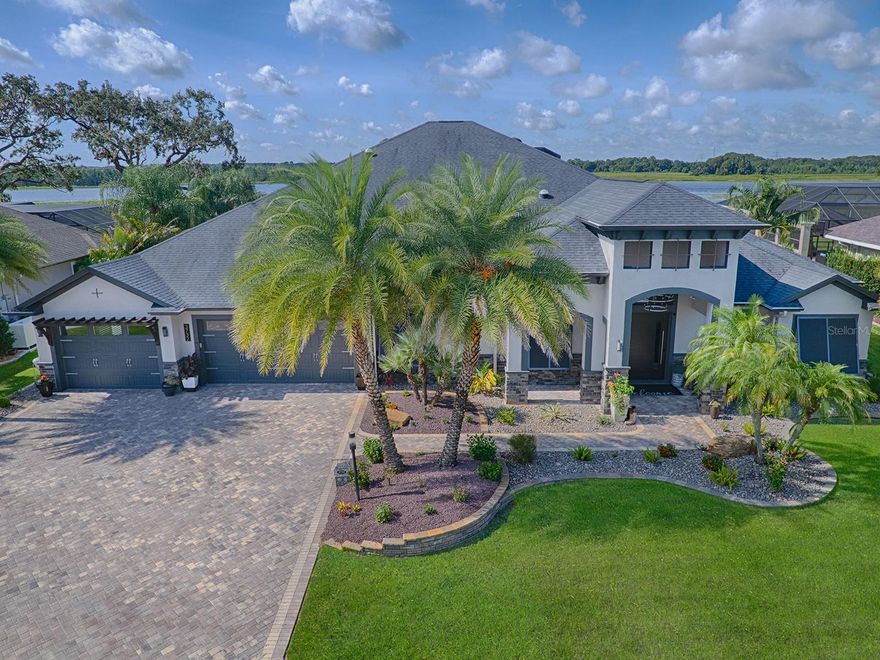 MAGNIFICENT IS AN UNDERSTATEMENT ON THIS CUSTOM, LUXURIOUSLY APPOINTED, ONE-OF-A-KIND, 4 BEDROOM, 4.5 BATH PREMIER HOME WHICH INCLUDES 2 MASTER SUITES, and the MOST AMAZING RESORT-STYLE POOL and SPA UNDER a MASSIVE 14,000 sf BIRDCAGE you’ll ever find in THE VILLAGES COMMUNITY; PANORAMIC LAKE VIEW and a 6+ CAR SPECTACULAR GARAGE, UNDER HEAT and AIR! The architectural design, character and uniqueness of the outside of the home, will prepare you for the same SPECTACULAR features you will find inside! Upon entering through the MAJESTIC PIVOT FRONT DOOR, you will be amazed at the luxurious, INVITING, comfortable interior. WOOD-LOOK PORCELAIN TILE flooring flows throughout the entire home excluding luxurious carpet in the 2 front guest rooms. You’ll find 10‘ BARN doors and crushed quartz walls that lead to the 2 guest rooms and guest bath! The REMARKABLE open kitchen has DEKTON counter tops offering beauty and functionality with a FARMHOUSE SINK, MIELE built-in COFFEE SYSTEM, all STAINLESS KITCHENAID appliances which includes a SUB-ZERO BGE REFRIGERATOR and 5-burner GAS COOKTOP with HOOD! Around the corner is your wet SERVING BAR with 2 WINE CELLARS, under counter wine cooler and ICEMAKER and easy access to the STUNNING GREAT ROOM and DINING ROOM. A SPECTACULAR, CUSTOM BUILT-IN ENTERTAINMENT CENTER with ELECTRIC FIREPLACE covers an entire wall of the great room; both rooms have GORGEOUS TRAY CEILINGS with CROWN TRIM, lighting and INSET ACACIA WOOD. Through MASSIVE STACK BACK SLIDING GLASS DOORS in the living room and FRENCH DOORS from the dining room, this part of the home seamlessly BLENDS INDOOR and OUTDOOR LUXURY LIVING! There are no words to describe this BREATHTAKING, RESORT-STYLE OUTDOOR LIVING SPACE and POOL!  There are 2 sitting areas, dining area and SUMMER KITCHEN with TRAVERTINE flooring, custom WOOD CEILING, custom LIGHTING, FANS, and FIREPLACE! The entire pool is surrounded with concrete pillars; DRAMATIC lighting is everywhere along with 5 GAS FIREBOWLS and ORBS!  REMARKABLE WATERFALLS, a river, beach entrance, SPA and even a GROTTO!  You’ll never tire of the MAGNIFICENT VIEW the PRESERVE has to offer with GORGEOUS SUNSETS, wildlife and different birds with every SEASON! The SUMMER KITCHEN has an AOG GAS GRILL with STAINLESS HOOD, GRANITE COUNTERS, sink, refrigerator and icemaker with a LOVELY STONE bar and one of two in this area, a DAYLIGHT BRIGHT OUTDOOR TV! The SPACIOUS MASTER SUITE with lounging area, has a HUGE WALK-IN closet with CUSTOM SYSTEM, large TRAY CEILING with CROWN TRIM and lighting, REMOTE CONTROL SUNSHADES and FRENCH DOORS that open out to the POOL and SPA!  Enter through the barn door to the EN-SUITE MASTER BATH which offers a large WALK THROUGH SHOWER with SOAKING TUB, DUAL sinks and counters. The 2 guest rooms, guest bath and the other MASTER SUITE are on the opposite side of the home offering everyone PRIVACY. The 2nd MASTER SUITE has FRENCH DOORS that open out to the STUNNING POOL area.  The EN-SUITE bath has a large walk-in closet, BEAUTIFUL ROMAN SHOWER, and as much space and upgrades as the master bath. The laundry room and half bath are in the hallway leading to the AMAZING GARAGE with EXPOXY flooring, INSULATED DOORS, storage rooms, another air conditioned separate “craft room”, office, etc. This SPECTACULAR home is located in a private enclave on the SHARON ROSE WIECHENS PRESERVE but still just a short golf cart ride to DINING, SHOPPING, GOLF, and ALL OF THE ACTIVITIES THE VILLAGES HAS TO OFFER!