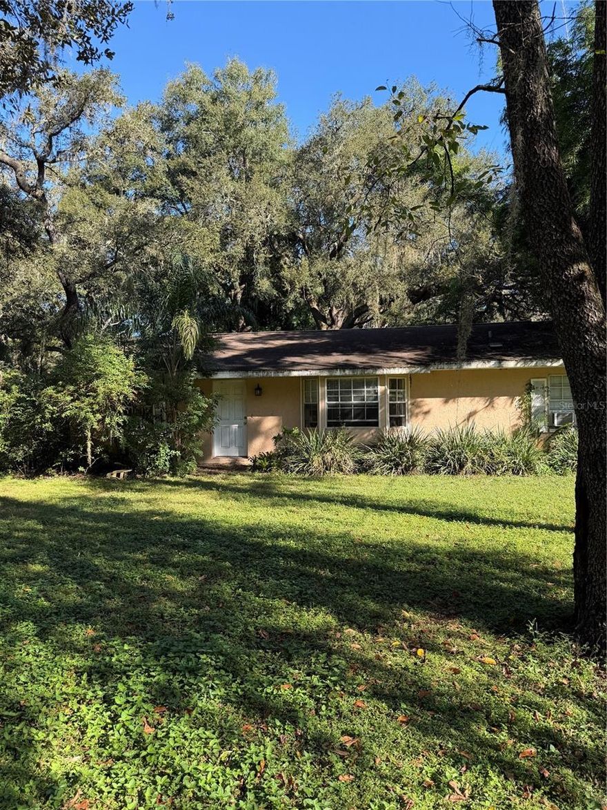 Perfect property for those wanting a small horse property and a fixer upper to make the house your own. The home will need a new roof and AC system, Owner will make no repairs. Room sizes should be verified. The property offers 2.74 acres of gorgeous lawn, oak trees and landscaping and could easily be the perfect set up for horses. There is a large pole barn that has two stall areas, large work room that could double as a carport, another smaller area for a workshop or feed room, large hay loft and an attached chicken coop. This area of Dade City offers gorgeous properties and views, and a sense of being away from it all yet within minutes you will find shopping and restaurants.