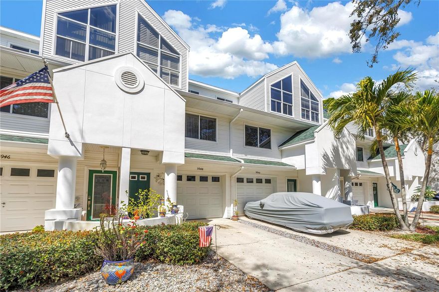 Enjoy watching dolphins, manatees, and a variety of sea birds from one of three screened balconies overlooking a peaceful saltwater canal. This well-maintained three-story townhouse in the charming Tara Cay community offers one of the largest floor plans available and is ready for its next owner.  The home features 4 spacious bedrooms, 4 full bathrooms, and a garage, making it ideal for multi-generational living, guests, or flexible space for a home office or game room. The first floor offers an excellent private in-law suite option, complete with a kitchenette, ensuite bathroom, and access to the screened lanai—providing a comfortable and private space for extended family or guests.  The main living level features a bright and inviting living and dining area with luxury engineered hardwood flooring and neutral finishes throughout. The updated kitchen is equipped with quartz countertops, stainless steel appliances, a breakfast bar, and ample cabinet space, making it perfect for both everyday living and entertaining.  Upstairs, the generously sized bedrooms include dual primary suites with his-and-hers walk-in closets and a porcelain-tiled primary shower. The laundry area is conveniently located on the third floor near the bedrooms, and the home offers abundant storage throughout.  The roof was replaced in 2025, providing added value and peace of mind.  Outdoor enthusiasts will appreciate the nearby kayak launch and the community dock located directly behind the unit where you can dock your boat. Residents also enjoy access to two community pools, and the HOA fees cover water, sewer, trash, basic cable, and community amenities. Located less than two miles from the Gulf beaches and close to the Florida Botanical Gardens, the Pinellas Trail, Publix, Walsingham Park, and top-rated Seminole schools, Tara Cay offers a peaceful setting with convenient access to shopping, dining, and everyday conveniences. Schedule your private showing today.