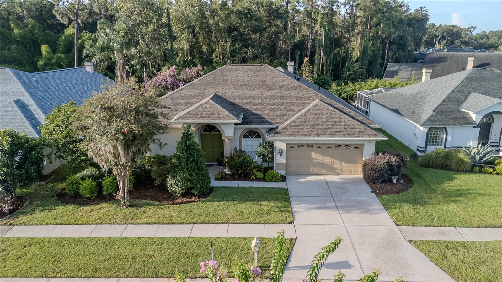 Immaculately maintained one-story home in the desirable Pebble Creek community, set on one of the most beautiful lots you’ll find. This property boasts a spacious screened lanai complete with both covered and open seating areas overlooking a serene conservation lot and lush, meticulously cared-for landscaping, including a stately magnolia tree and vibrant crape myrtle. Inside, the split floor plan offers 3 bedrooms, 2 baths, and a 2-car garage. Gleaming real wood floors with extra padding flow throughout the main living areas and bedrooms. At the heart of the home, the kitchen features abundant cabinetry, granite countertops, stainless steel appliances and a pantry. The cozy family room is anchored by a wood-burning fireplace and offers pocket sliders that open wide to the lanai, creating a seamless indoor-outdoor living experience. The spacious primary suite includes French doors to the lanai, a large walk-in closet, and an en-suite bath with dual vanities, a garden tub, and a separate shower. Two additional bedrooms, located on the opposite side of the home, share a well-appointed hall bath. The laundry room, with built-in cabinets, provides extra storage space. Recent updates include fresh interior and exterior paint, new lighting, NEW ROOF 2025, new wood fence (2025), and all-new gutters (2024). Pebble Creek residents enjoy no CDD, a low HOA fee of just $650/year, and access to community amenities such as a pool, tennis court, playground, and frequent neighborhood events. The location offers easy access to major highways and is just minutes from premium shopping and dining, hospitals, the University of South Florida, VA Hospital, and Moffitt Cancer Center and a short drive to downtown Tampa. Call today to schedule your private showing of this beautifully cared-for home!